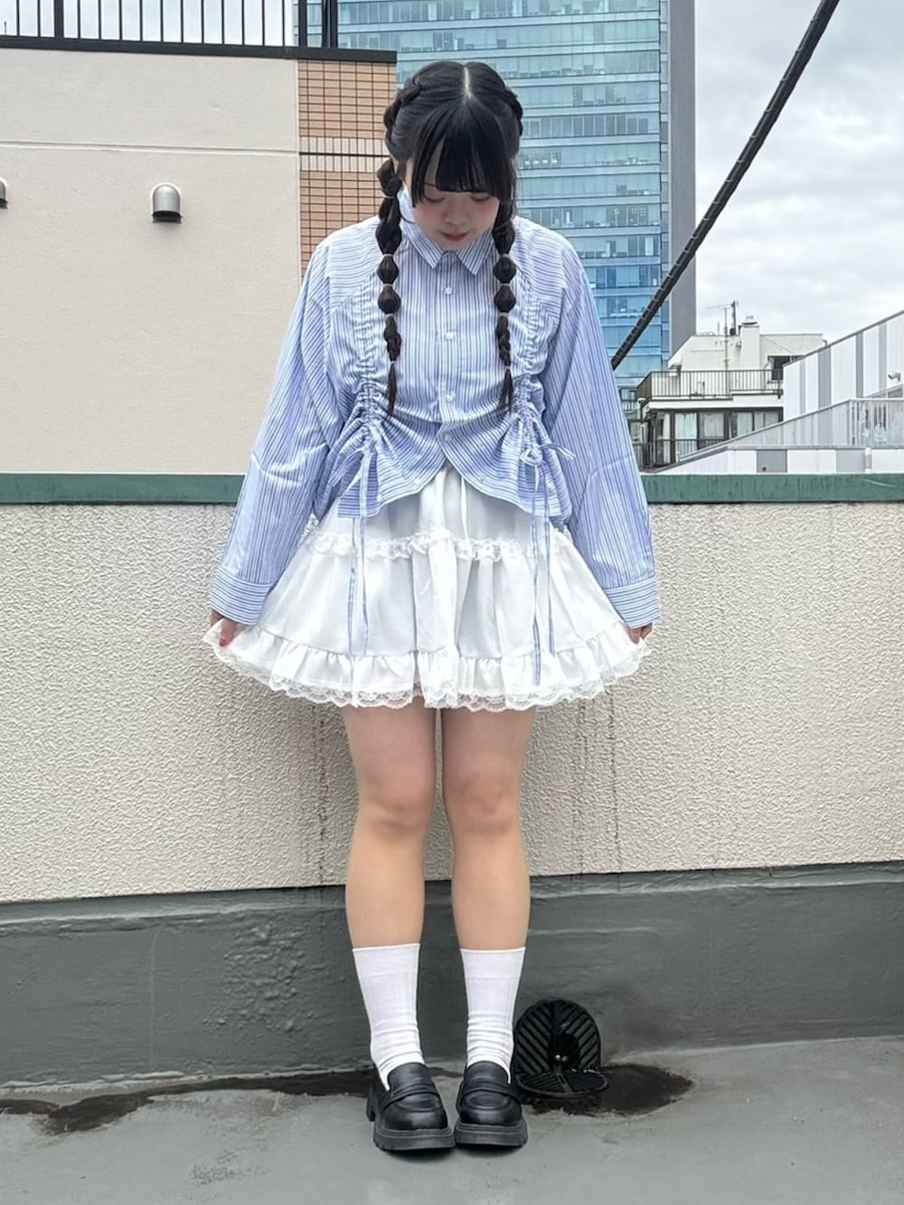 ホワイト系のスカート、ブルー系のシャツ/ブラウスを着用したレディースの春コーディネートの2枚目の写真