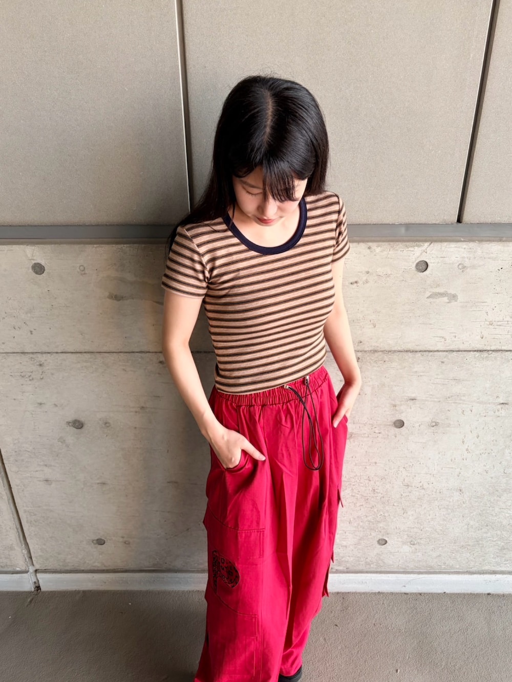 レッド系のカーゴパンツ、ブラウン系のTシャツ/カットソーを着用したレディースの夏コーディネートの4枚目の写真