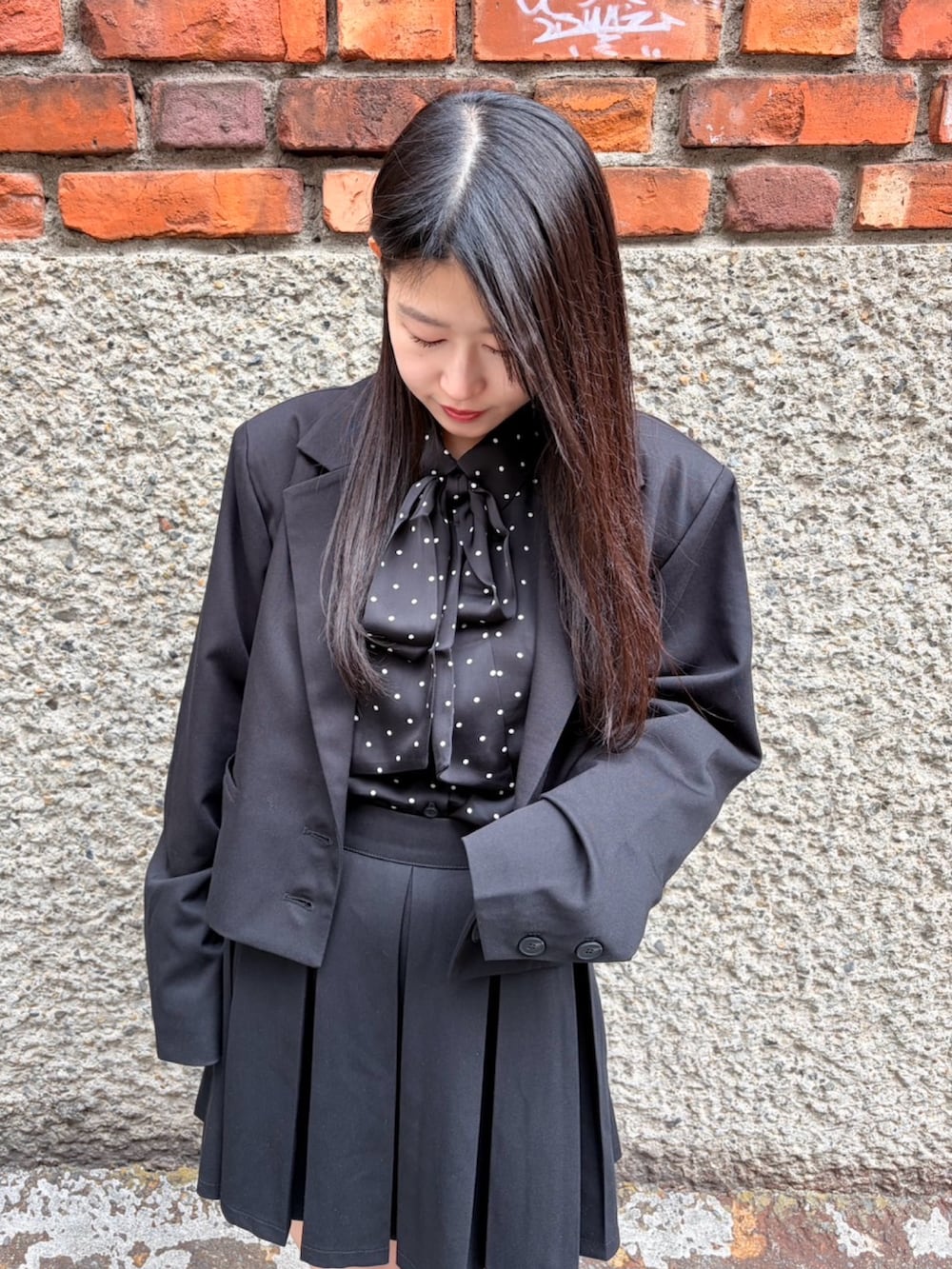 ブラック系のスカート、ブラック系のテーラードジャケット、ブラック系のシャツ/ブラウスを着用したレディースの冬コーディネートの5枚目の写真