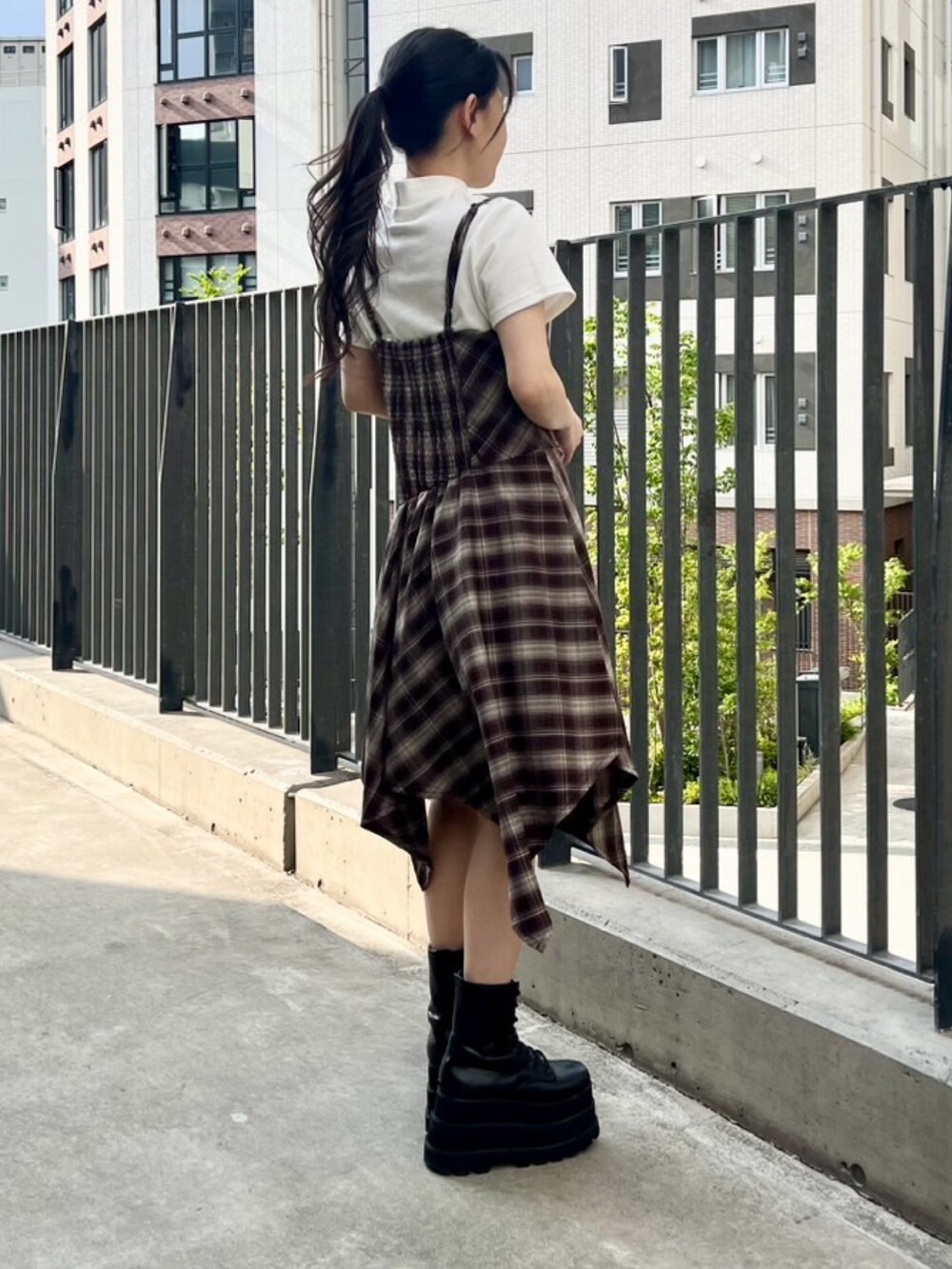 ブラウン系のワンピース、ホワイト系のTシャツ/カットソーを着用したレディースの春コーディネートの4枚目の写真