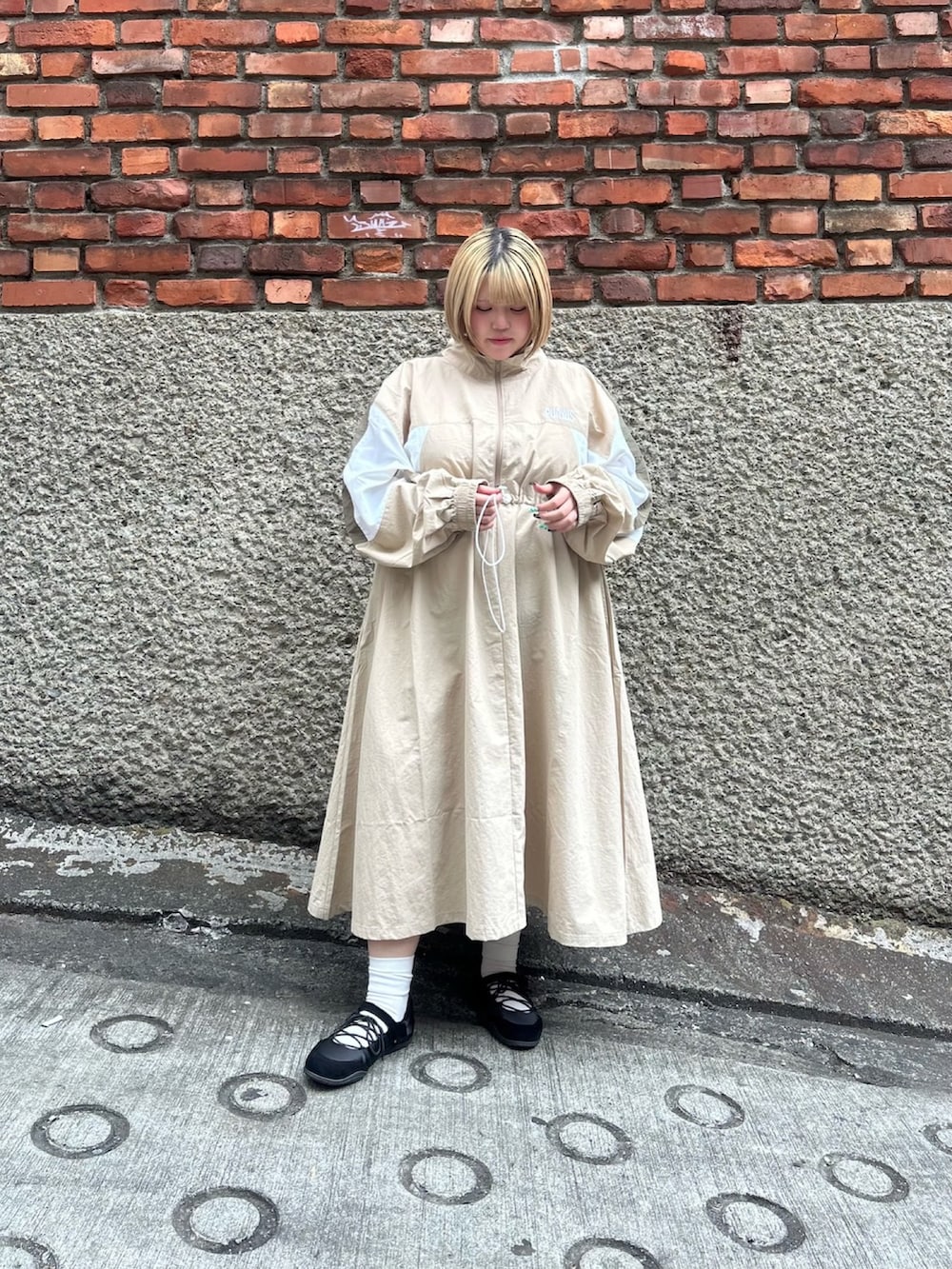 ベージュ系のワンピースを着用したレディースの春コーディネートの3枚目の写真