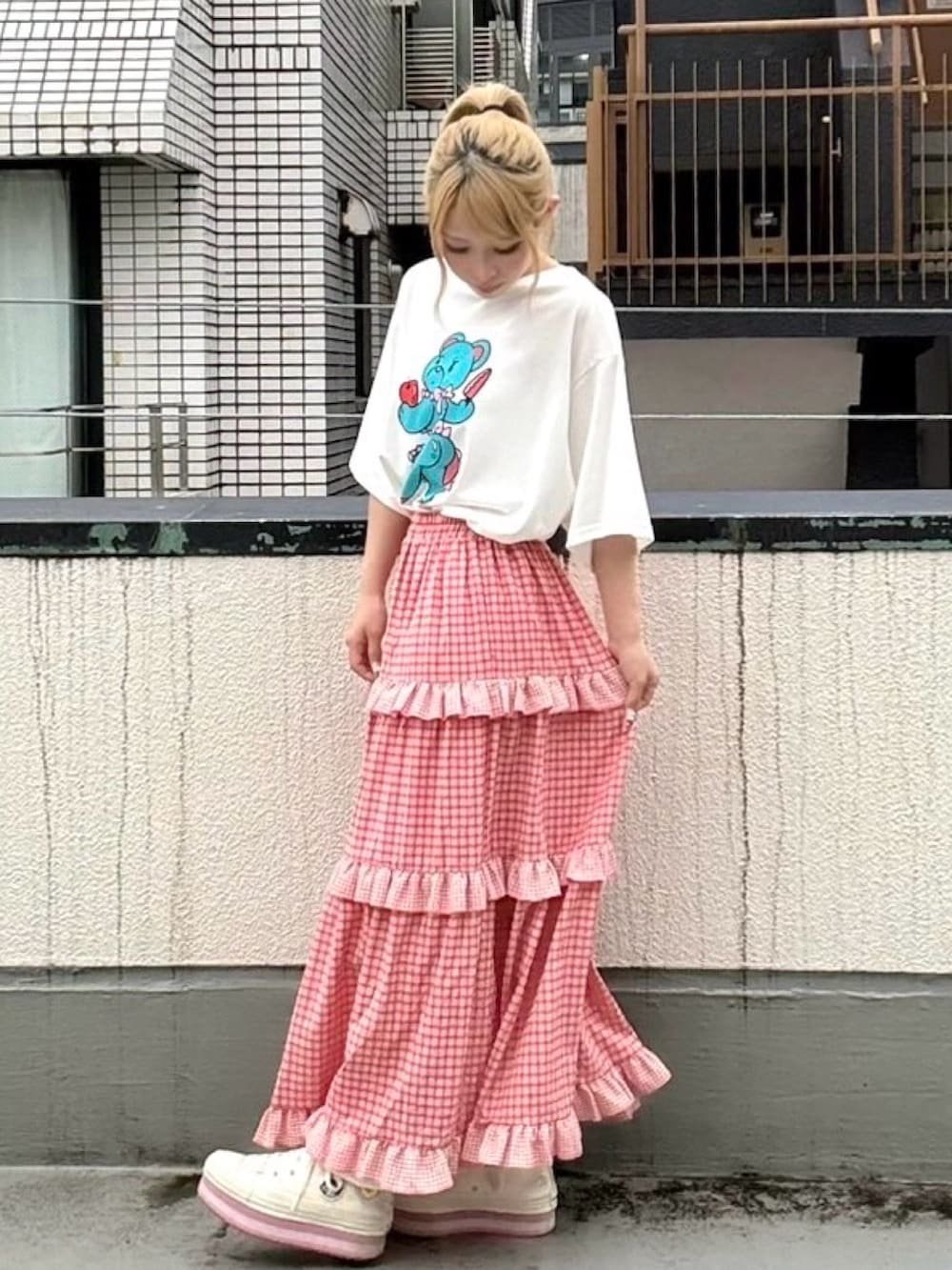 レッド系のスカート、ホワイト系のTシャツ/カットソーを着用したレディースの夏コーディネートの3枚目の写真