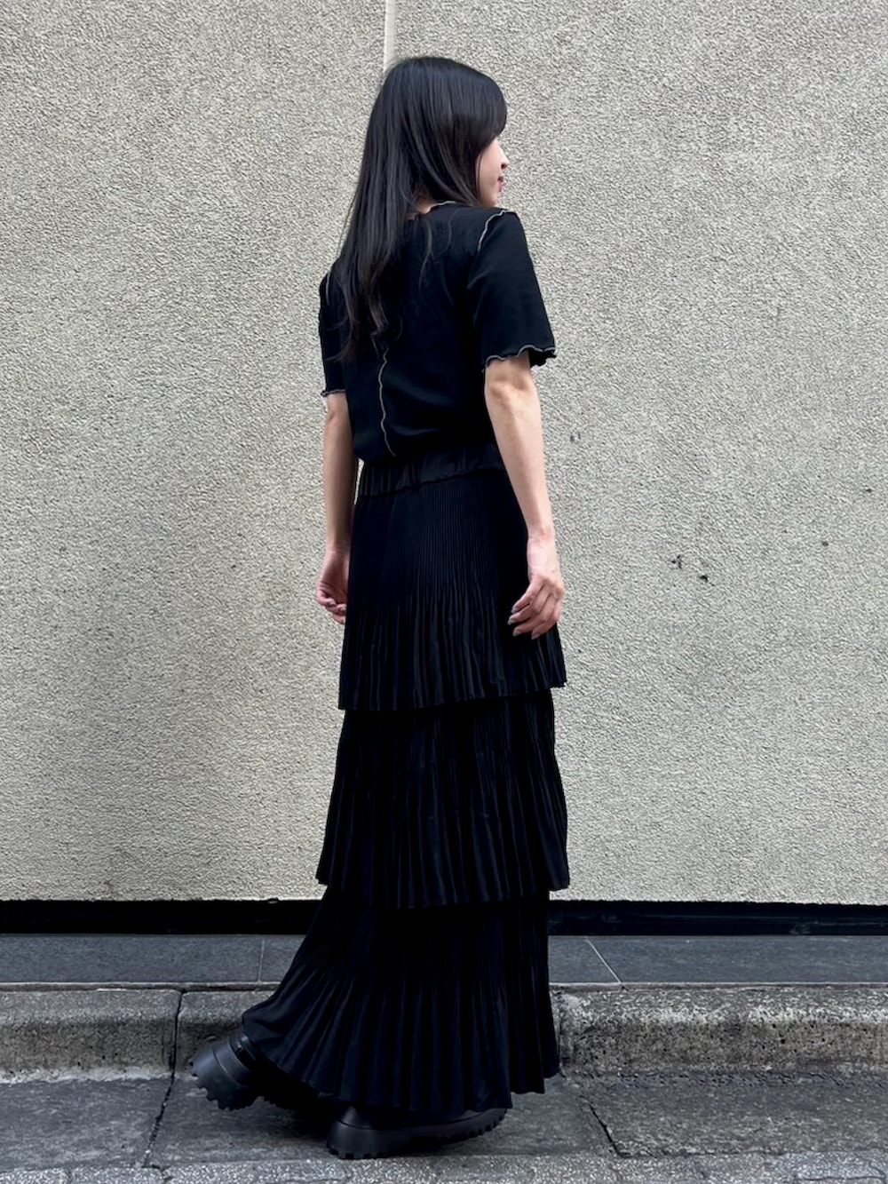 ブラック系のスカート、ブラック系のTシャツ/カットソーを着用したレディースの秋コーディネートの3枚目の写真