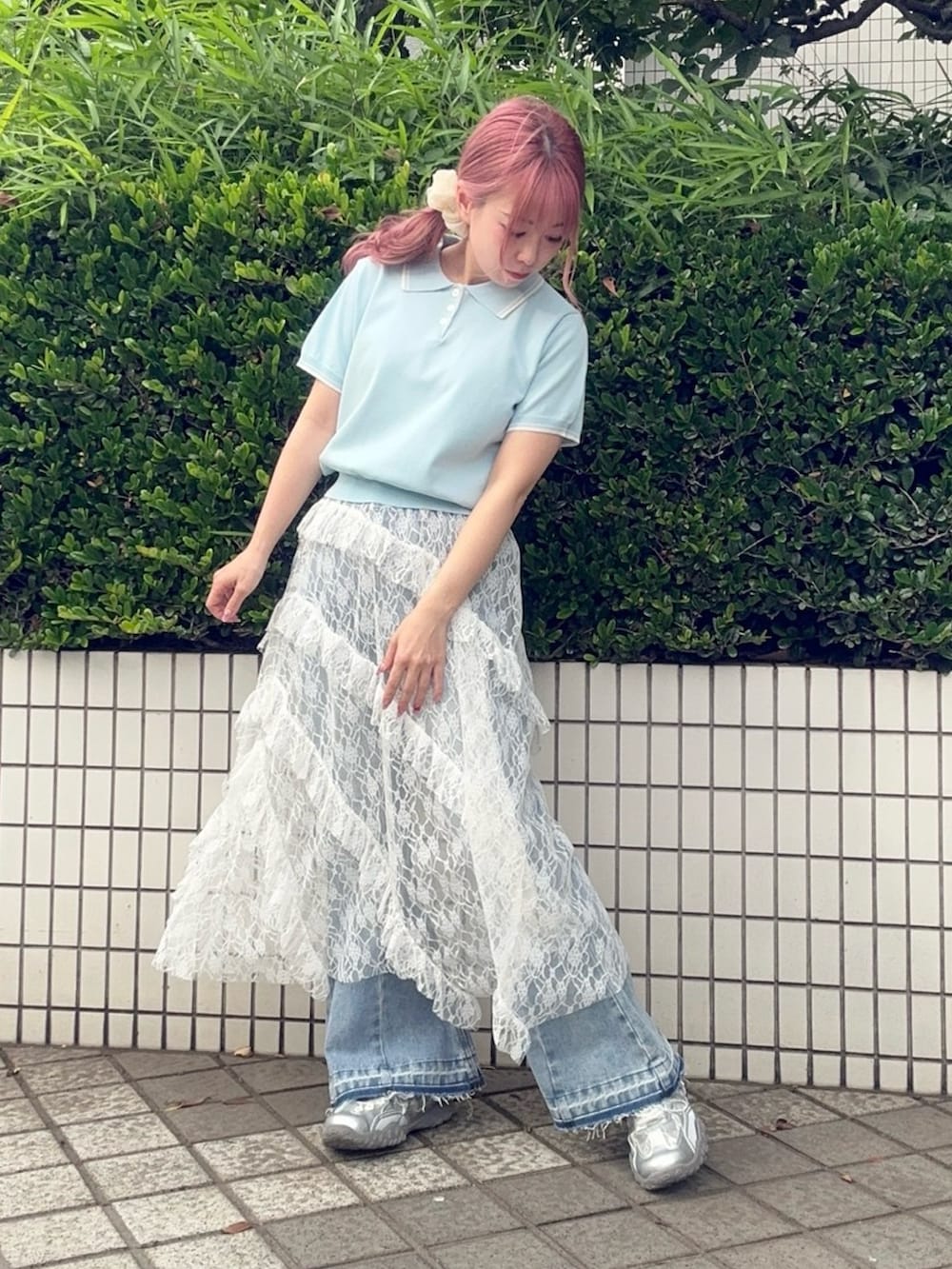 ホワイト系のスカート、ブルー系のポロシャツ、ブルー系のデニムパンツを着用したレディースの夏コーディネートの3枚目の写真