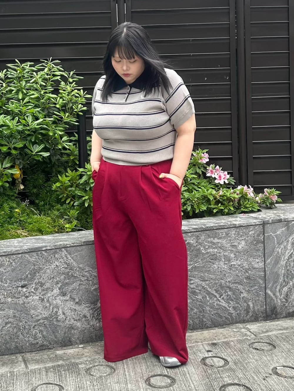 レッド系のその他パンツ、グレー系のポロシャツを着用したレディースの春コーディネートの2枚目の写真