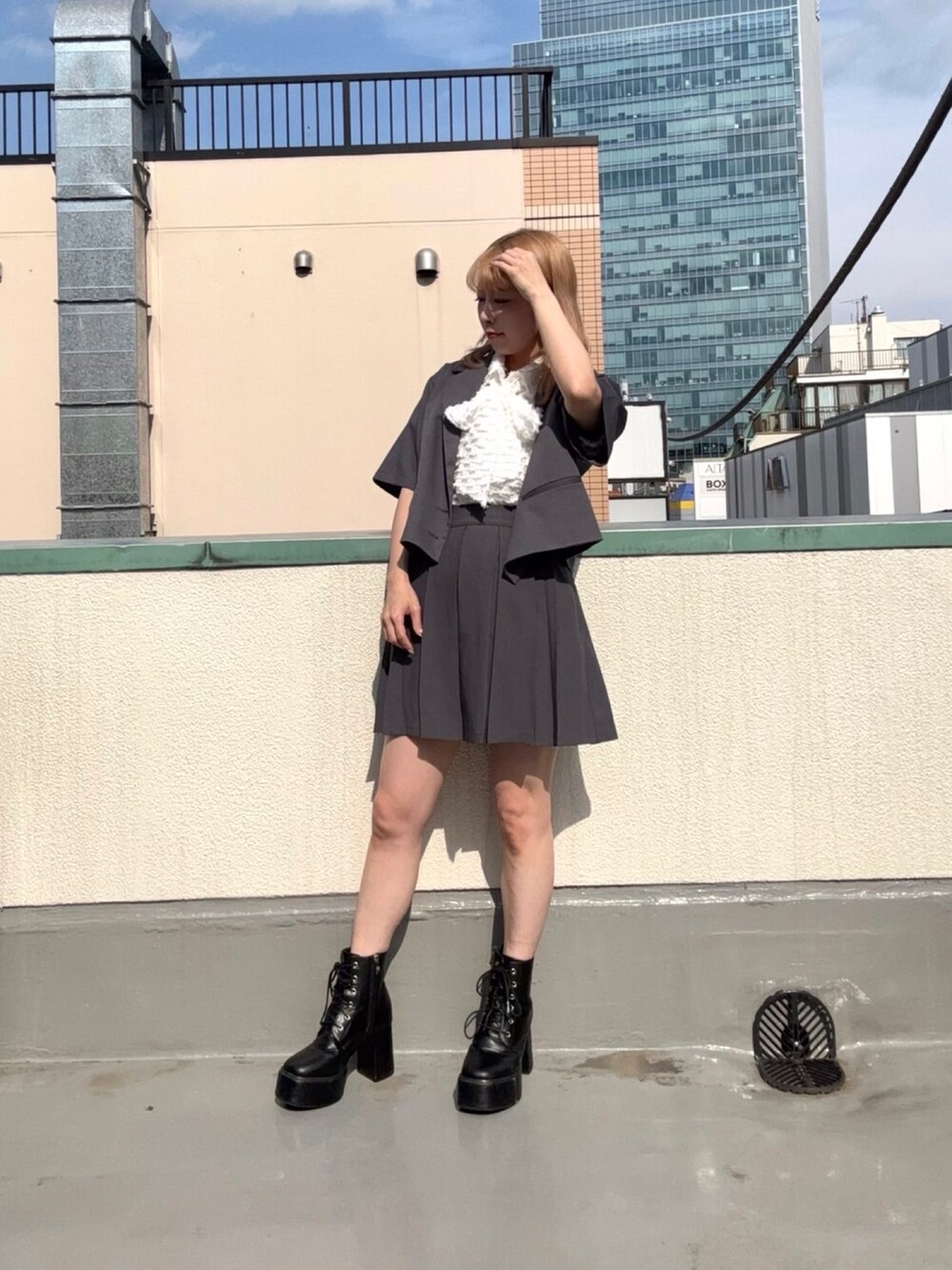 グレー系のテーラードジャケット、グレー系のスカート、ホワイト系のシャツ/ブラウスを着用したレディースの夏コーディネートの3枚目の写真