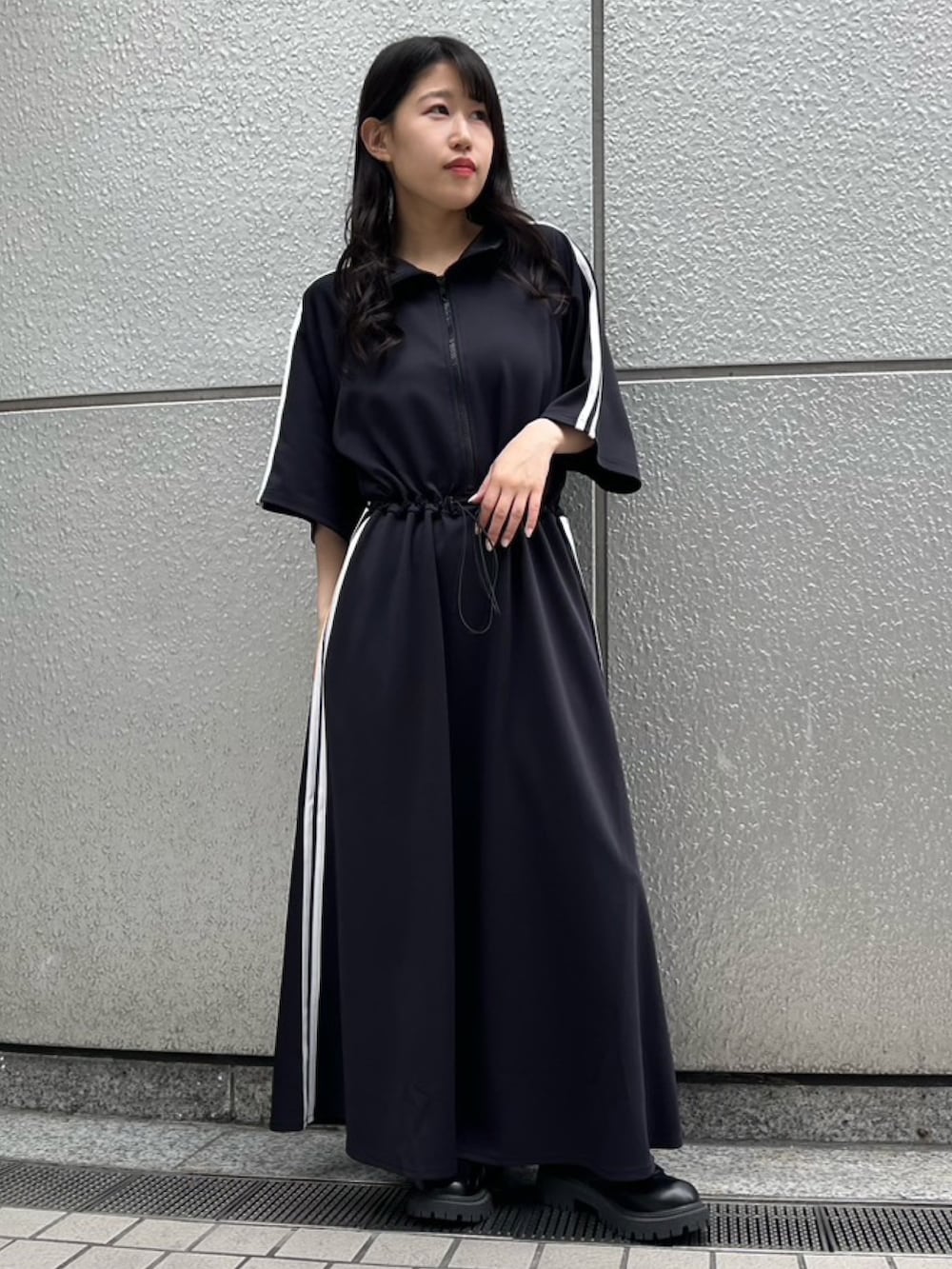 ブラック系のワンピースを着用したレディースの夏コーディネートの2枚目の写真
