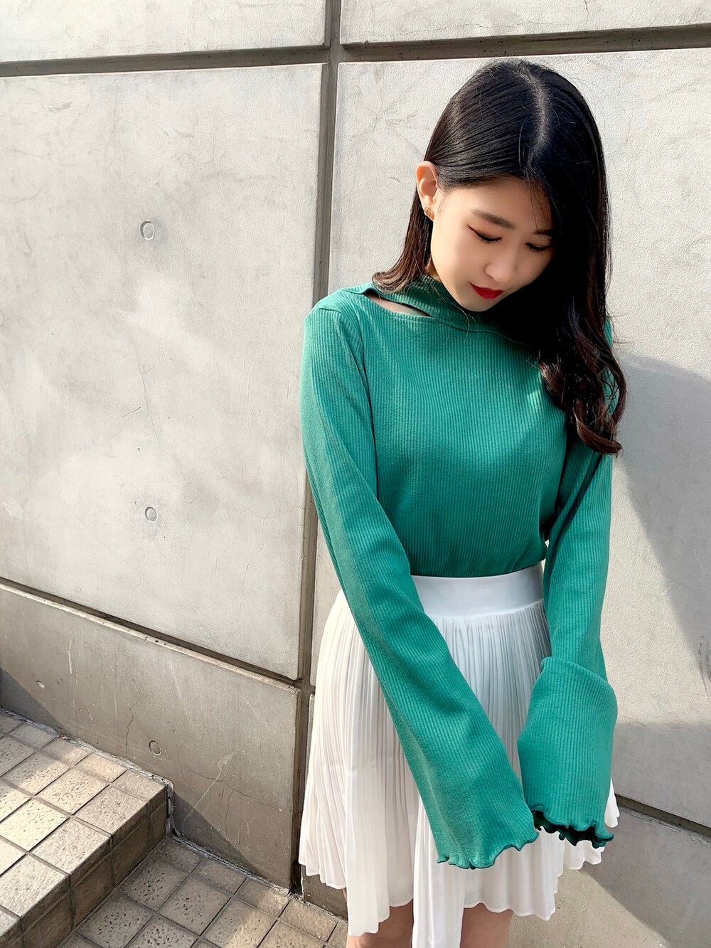 ブラック系のローファー、グリーン系のTシャツ/カットソー、ホワイト系のスカートを着用したレディースの春コーディネートの2枚目の写真