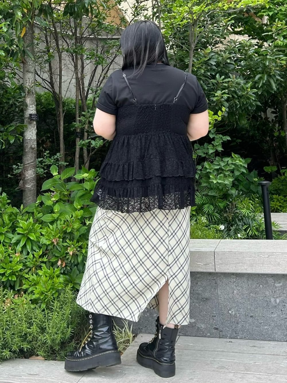 ベージュ系のスカート、ブラック系のワンピース、ブラック系のTシャツ/カットソーを着用したレディースの春コーディネートの4枚目の写真