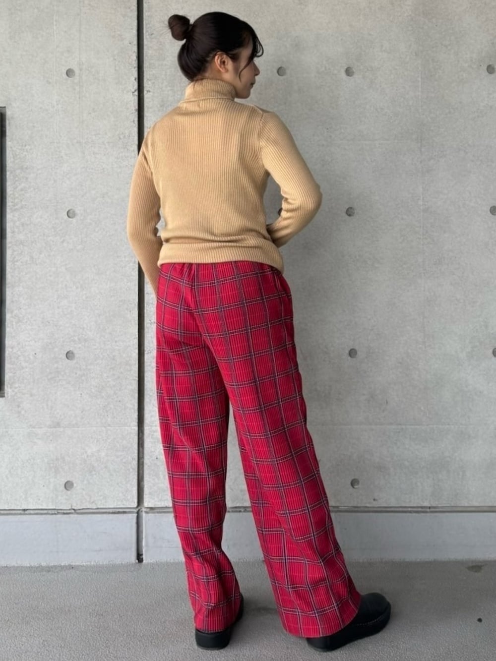 レッド系のその他パンツ、ベージュ系のニット/セーターを着用したレディースの冬コーディネートの4枚目の写真