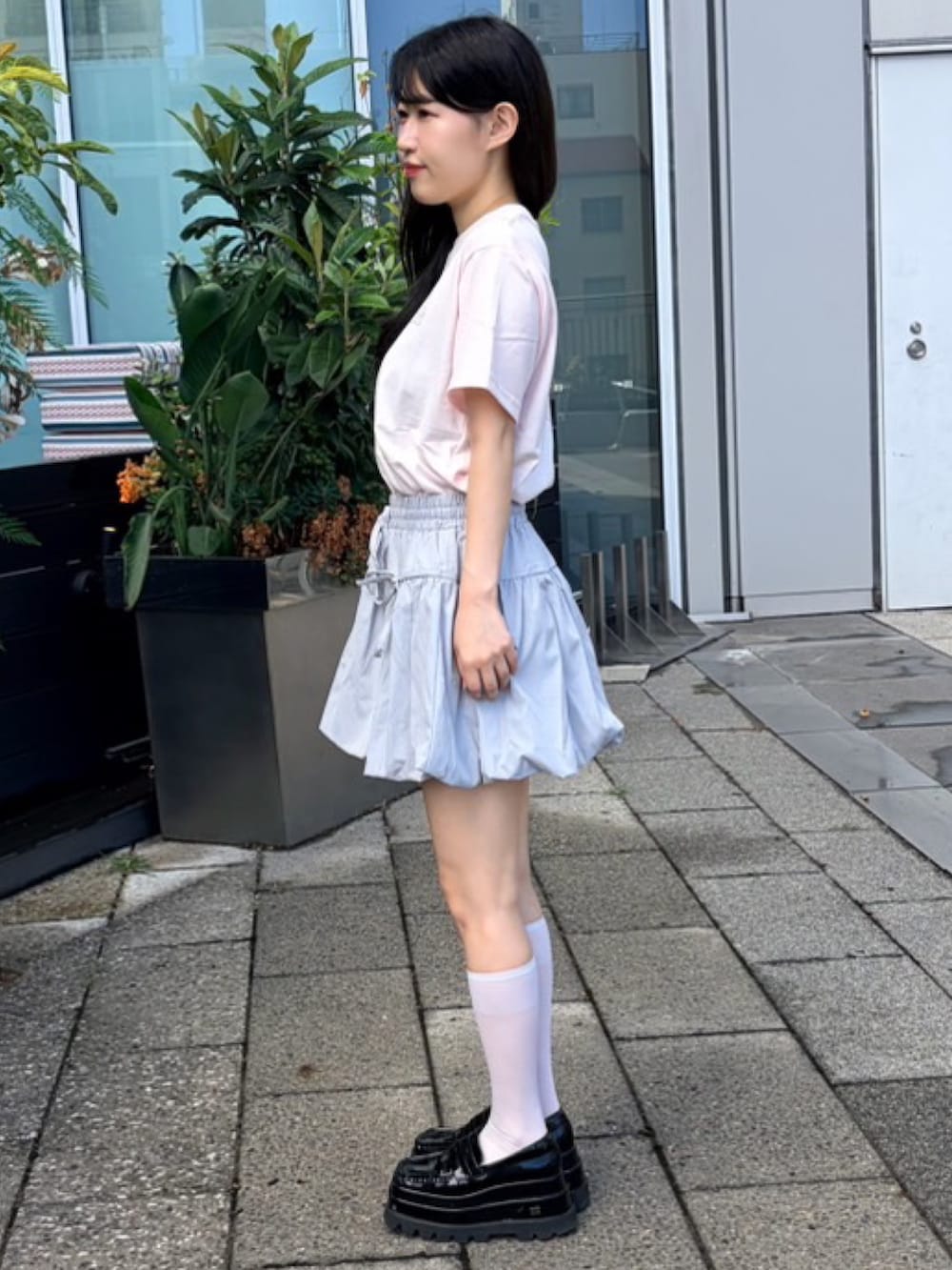グレー系のスカート、ピンク系のTシャツ/カットソーを着用したレディースの夏コーディネートの3枚目の写真