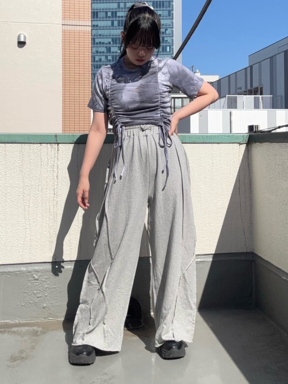グレー系のスウェットパンツ、パープル系のTシャツ/カットソーを着用したレディースの夏コーディネートの3枚目の写真