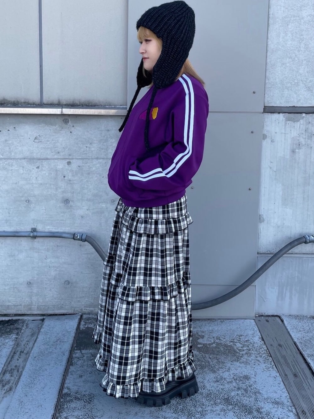 パープル系のジャージ、ホワイト系のスカートを着用したレディースの春コーディネートの2枚目の写真