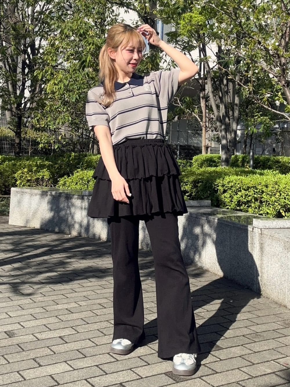 ブラック系のその他パンツ、グレー系のポロシャツを着用したレディースの春コーディネートの3枚目の写真