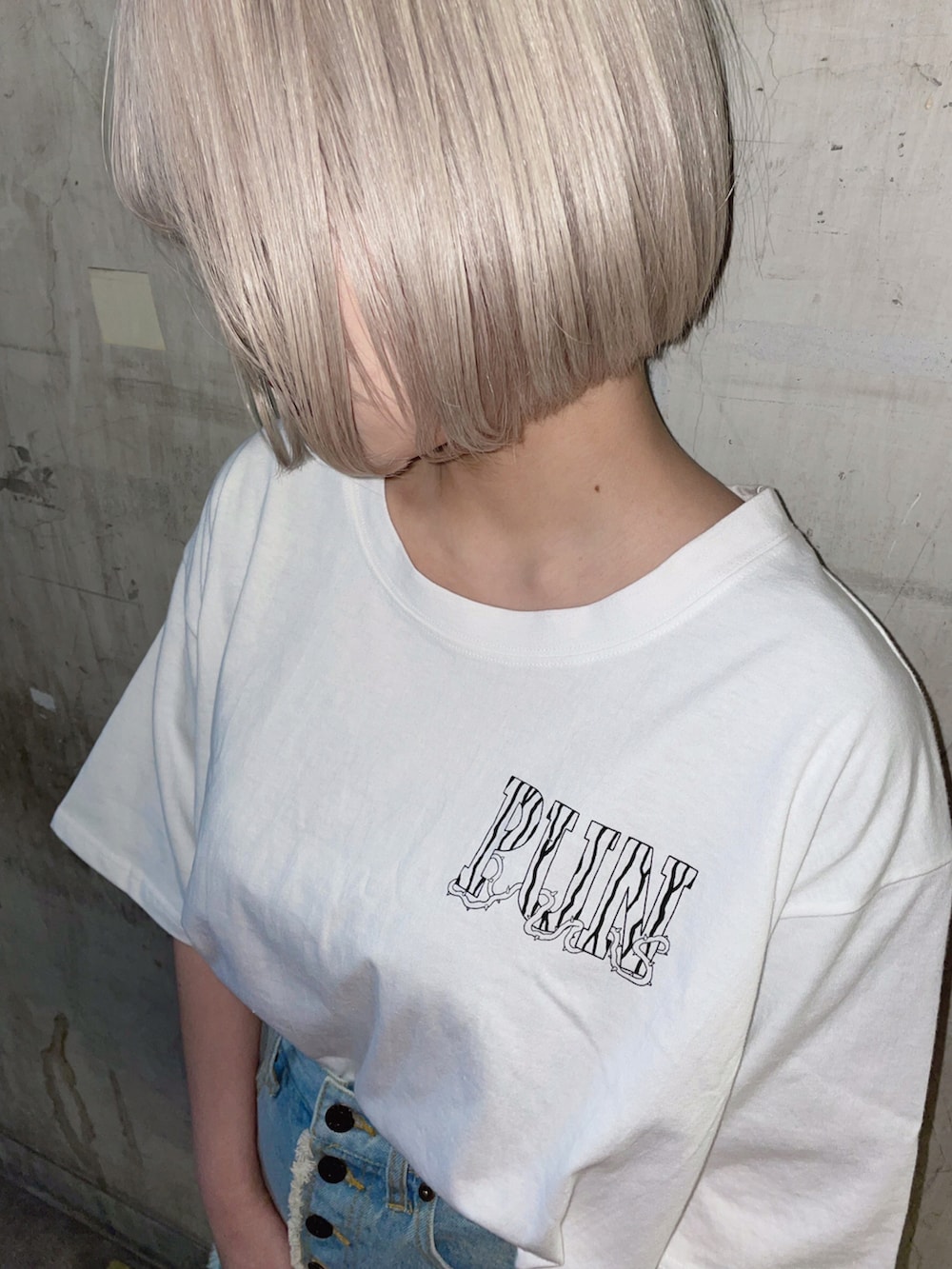 ホワイト系のTシャツ/カットソー、ブルー系のデニムスカートを着用したレディースの春コーディネートの2枚目の写真