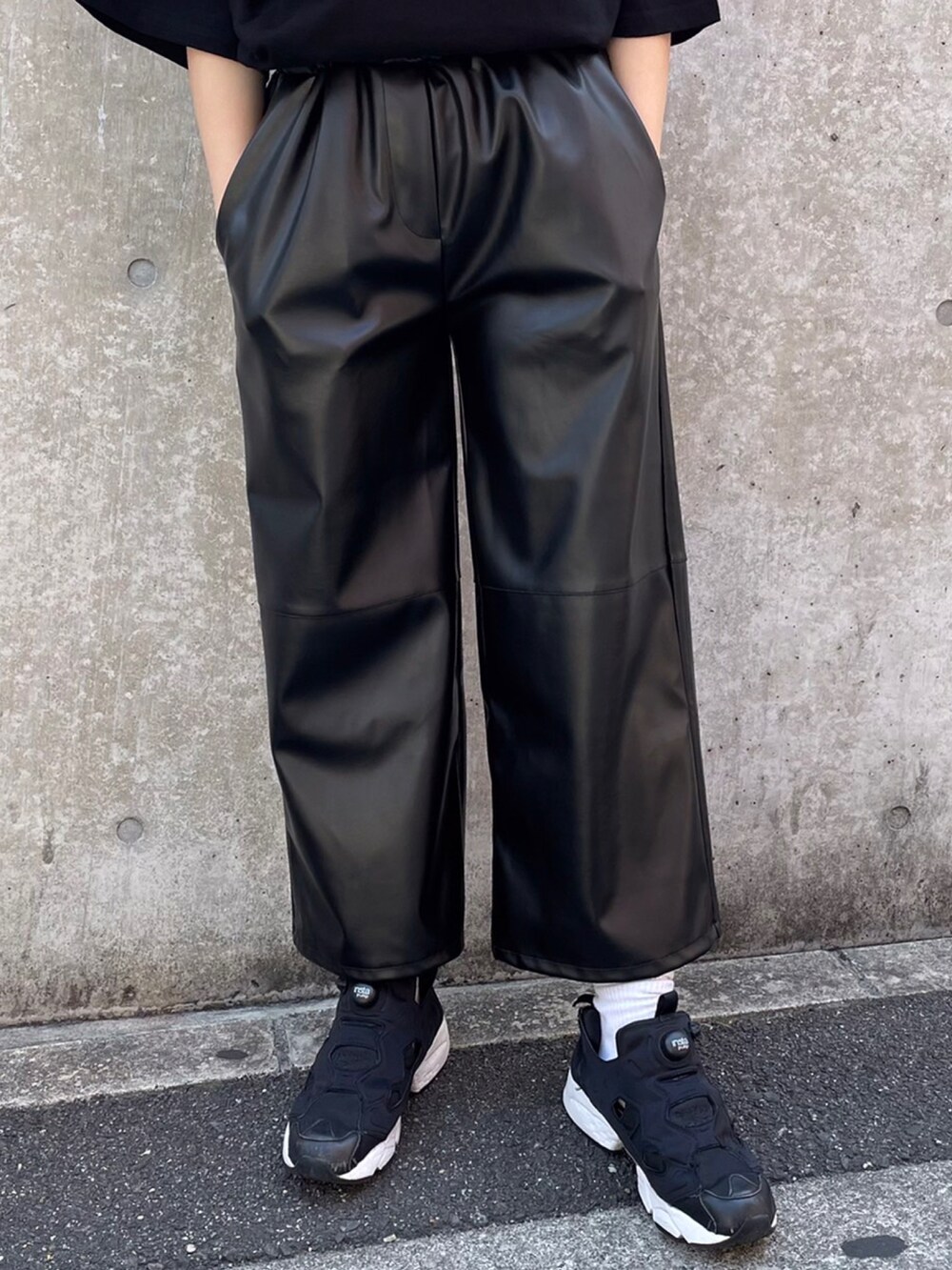 ブラック系のTシャツ/カットソー、ブラック系のパンツを着用したレディースの春コーディネートの3枚目の写真