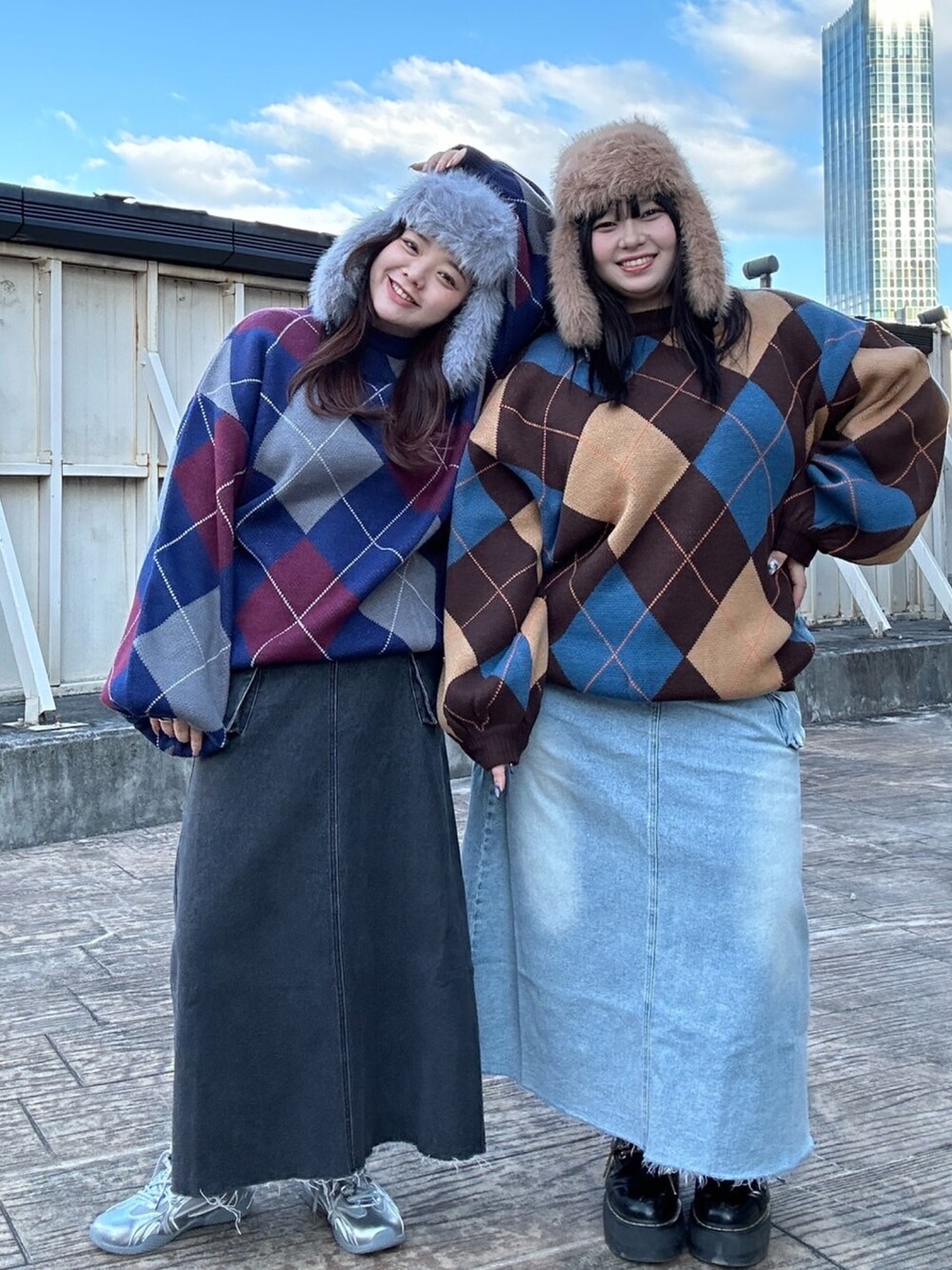 ブルー系のニット/セーター、ブラック系のデニムスカート、ブルー系のデニムスカートを着用したレディースの冬コーディネートの2枚目の写真