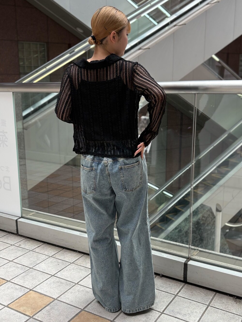 ブラック系のシャツ/ブラウス、ブルー系のデニムパンツを着用したレディースの秋コーディネートの4枚目の写真