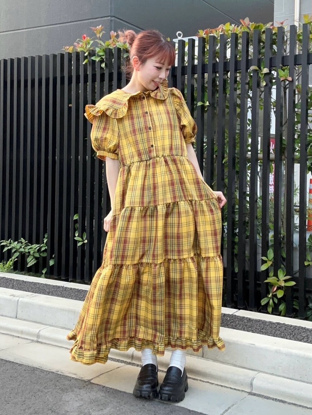 イエロー系のワンピースを着用したレディースの夏コーディネートの2枚目の写真