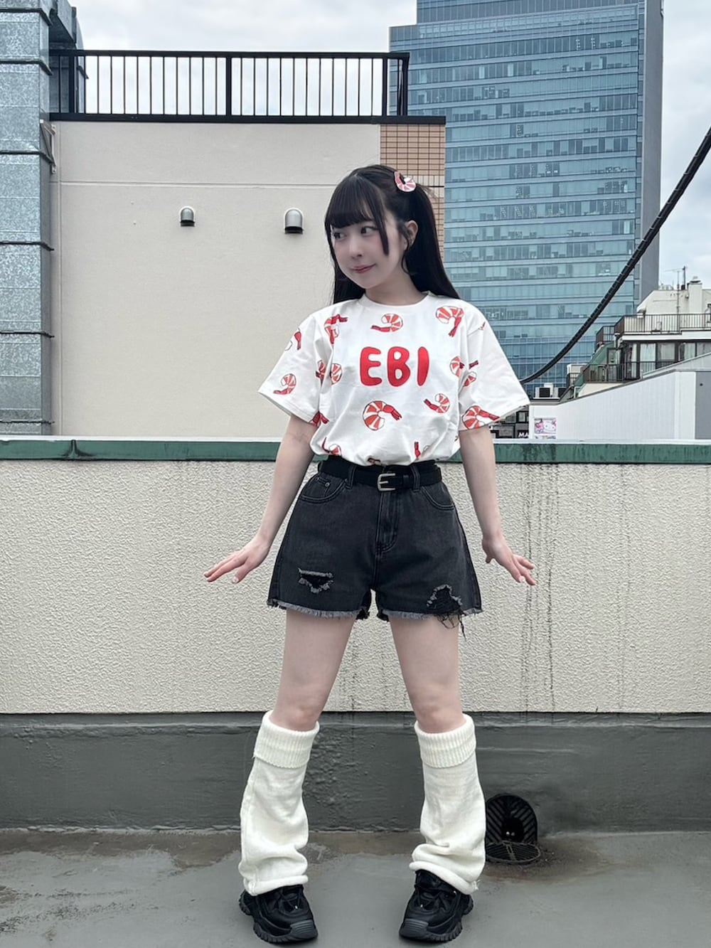 ブラック系のデニムパンツ、レッド系のTシャツ/カットソー、ブラック系のベルトを着用したレディースの春コーディネートの4枚目の写真
