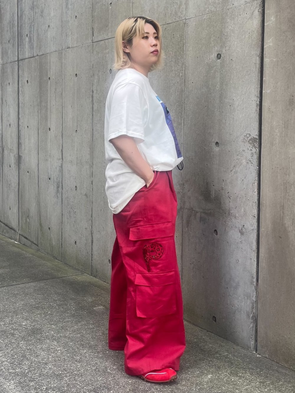 レッド系のカーゴパンツ、ホワイト系のTシャツ/カットソーを着用したレディースの夏コーディネートの4枚目の写真