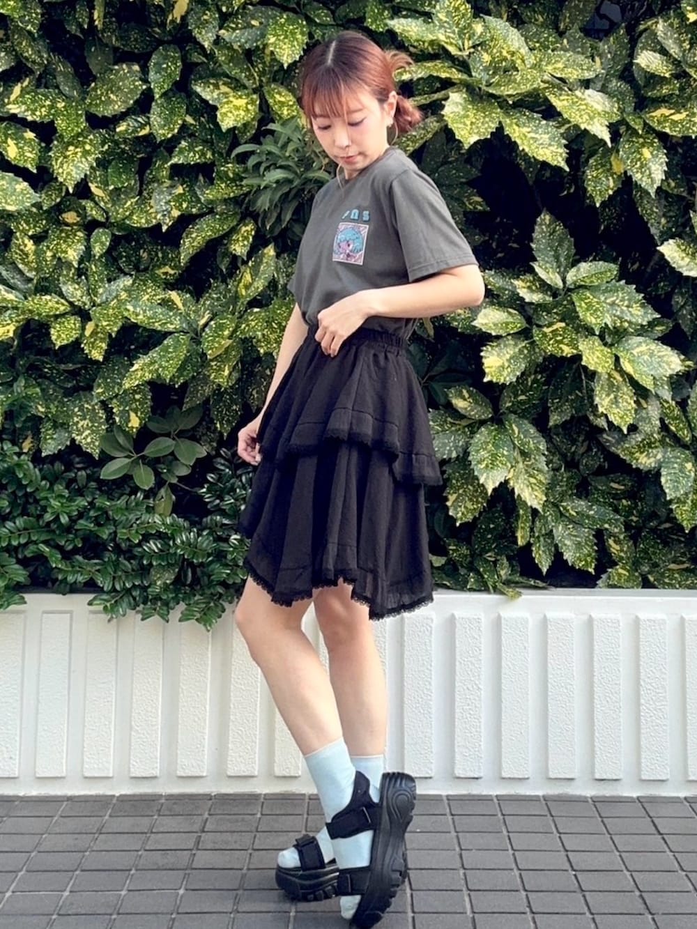 ブラック系のスカート、ブラック系のTシャツ/カットソーを着用したレディースの夏コーディネートの2枚目の写真