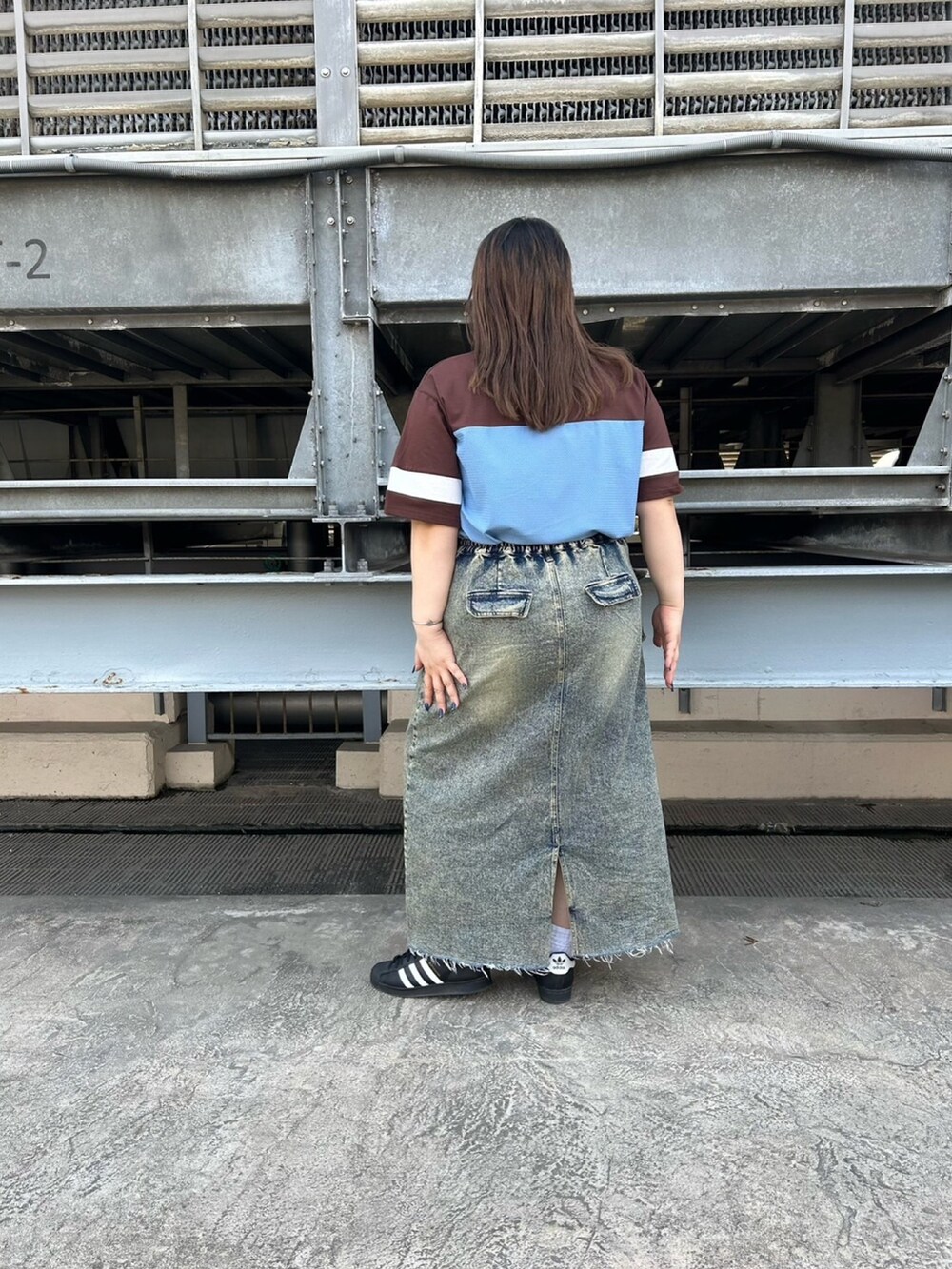 ブラウン系のTシャツ/カットソー、ブルー系のデニムスカートを着用したレディースの春コーディネートの3枚目の写真