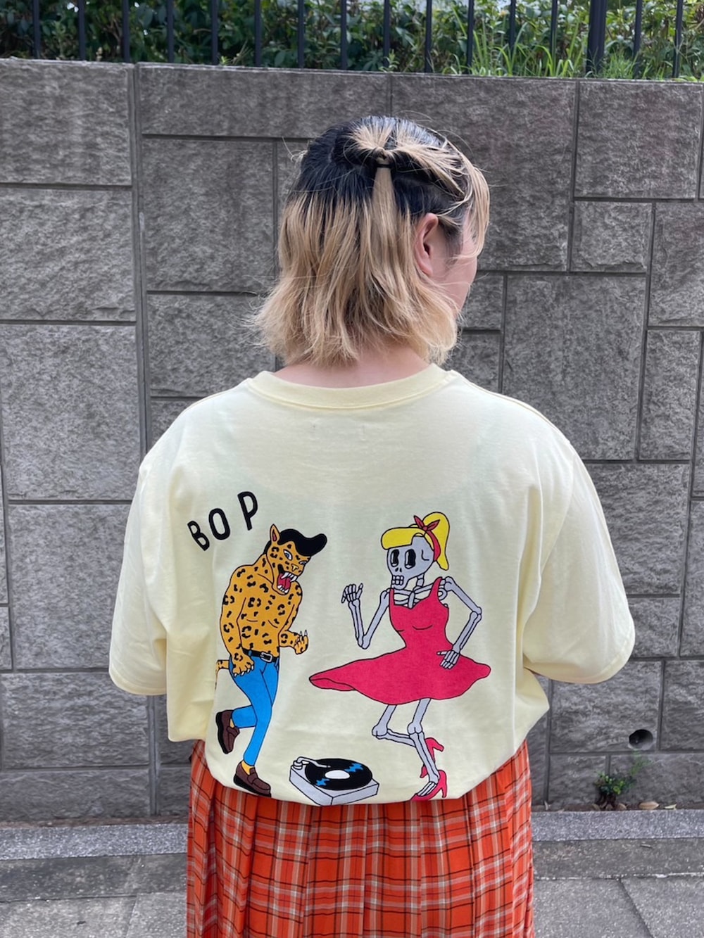 オレンジ系のスカート、イエロー系のTシャツ/カットソーを着用したレディースの夏コーディネートの4枚目の写真