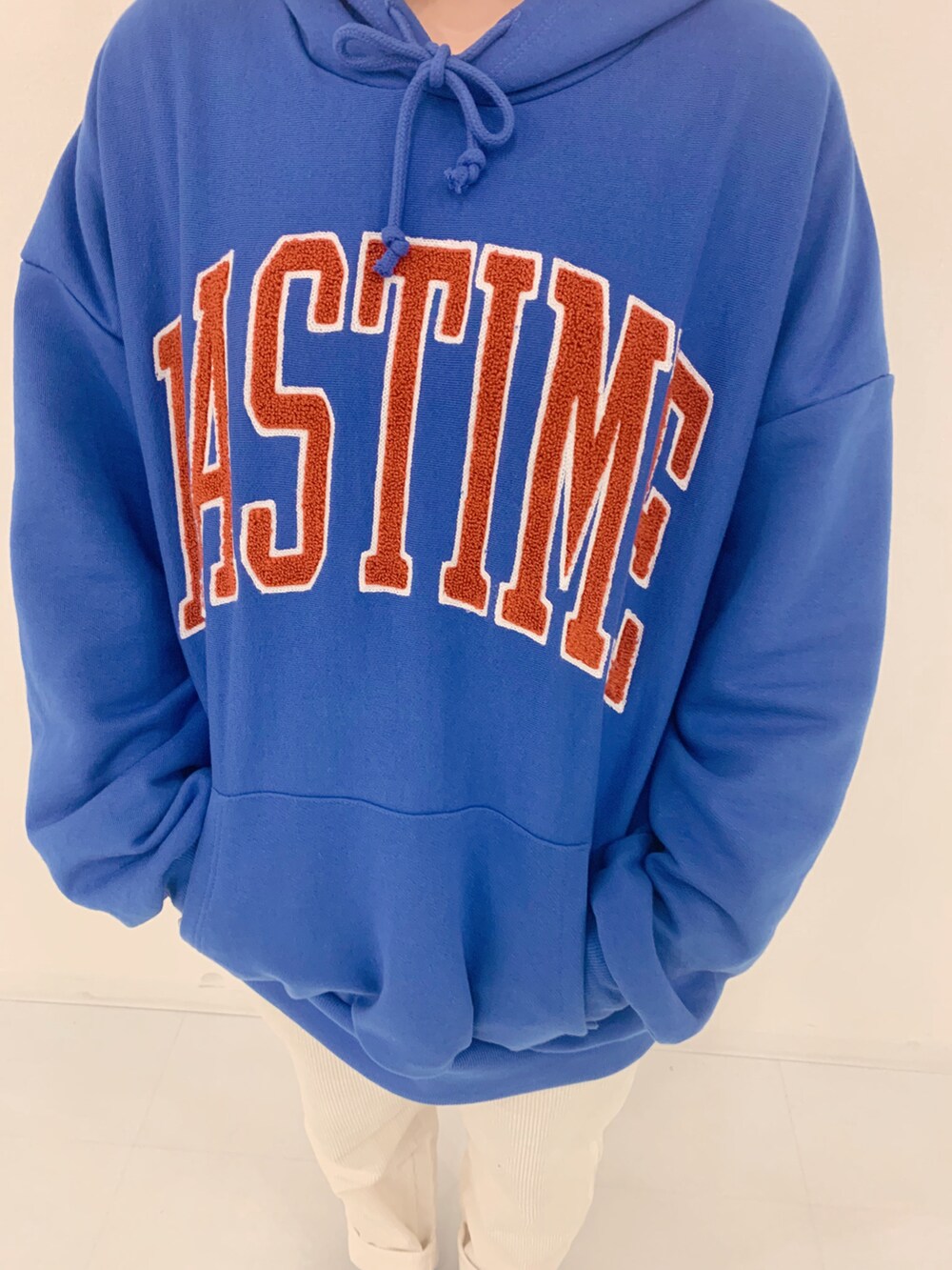 ブルー系のパーカー、ホワイト系のチノパンツを着用したレディースの冬コーディネートの2枚目の写真