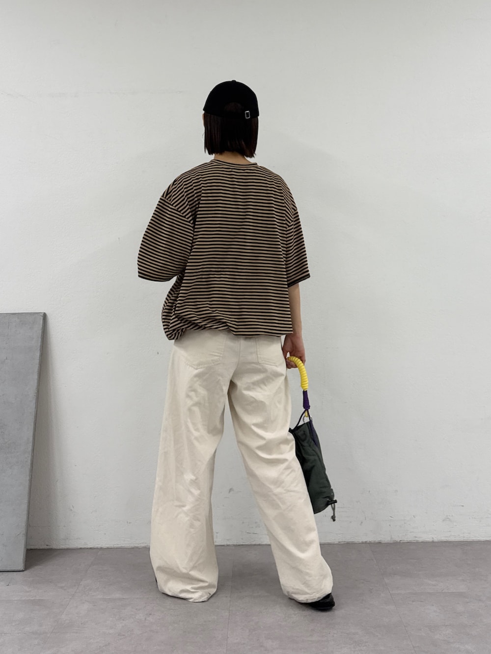 ベージュ系のTシャツ/カットソー、ホワイト系のデニムパンツ、グリーン系のトートバッグを着用したレディースの夏コーディネートの4枚目の写真