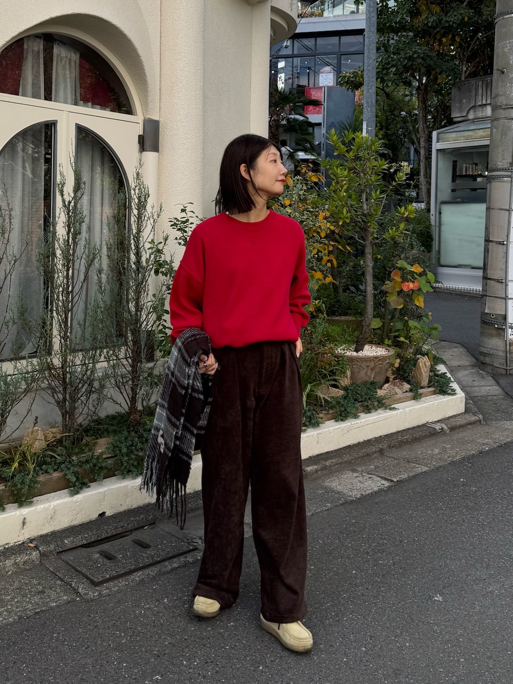 ブラウン系のスラックス、レッド系のニット/セーターを着用したレディースの秋コーディネートの3枚目の写真