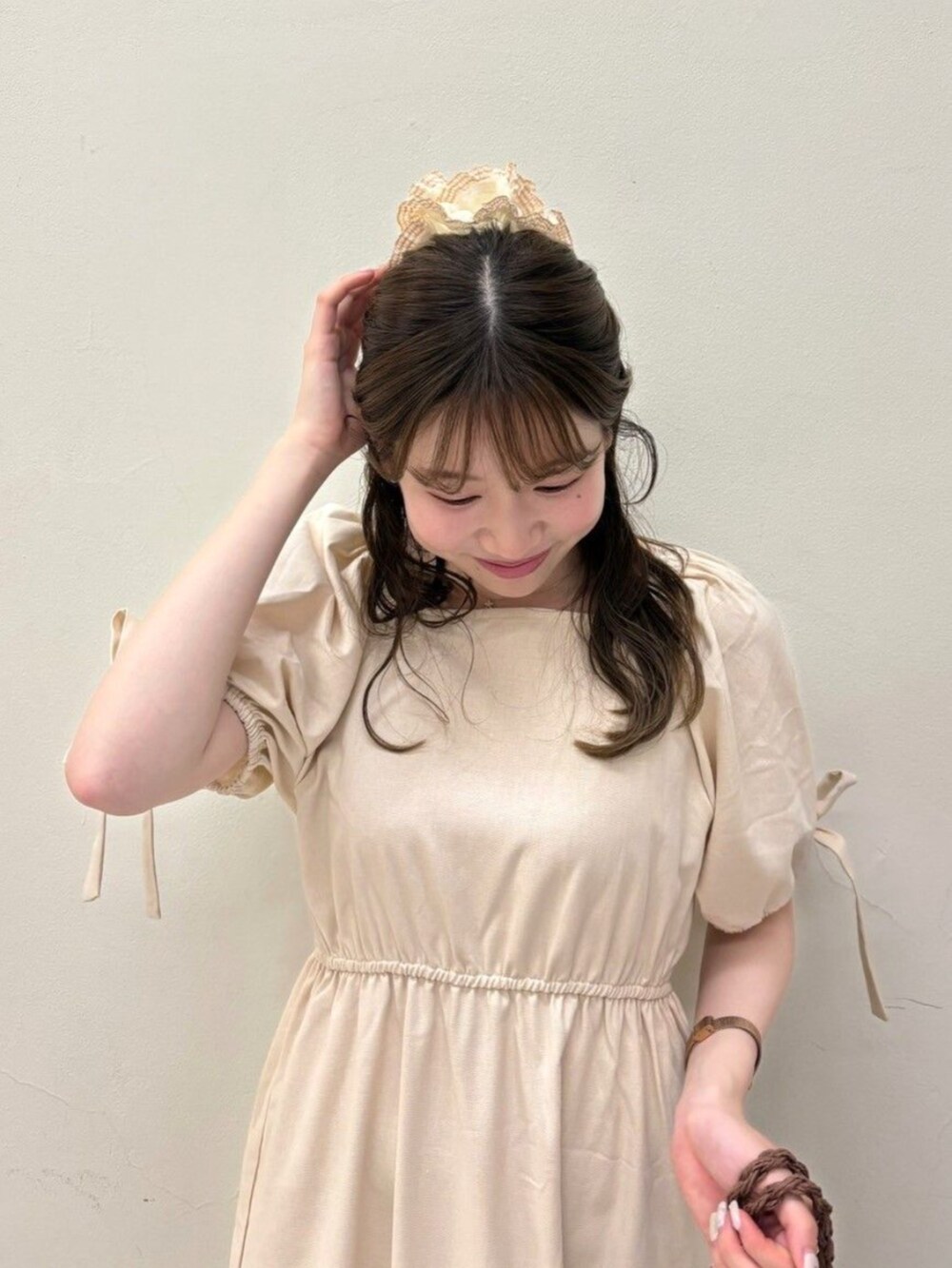 ホワイト系のワンピース、ブラウン系のトートバッグ、ゴールド系のバレエシューズを着用したレディースの夏コーディネートの3枚目の写真