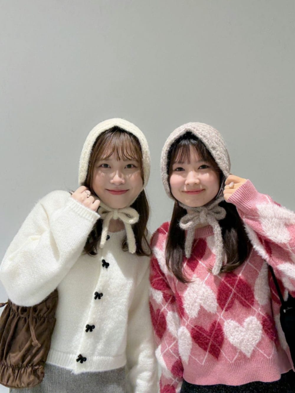 ブラック系のスカート、レッド系のニット/セーター、ブラック系のショルダーバッグを着用したレディースの秋コーディネートの3枚目の写真