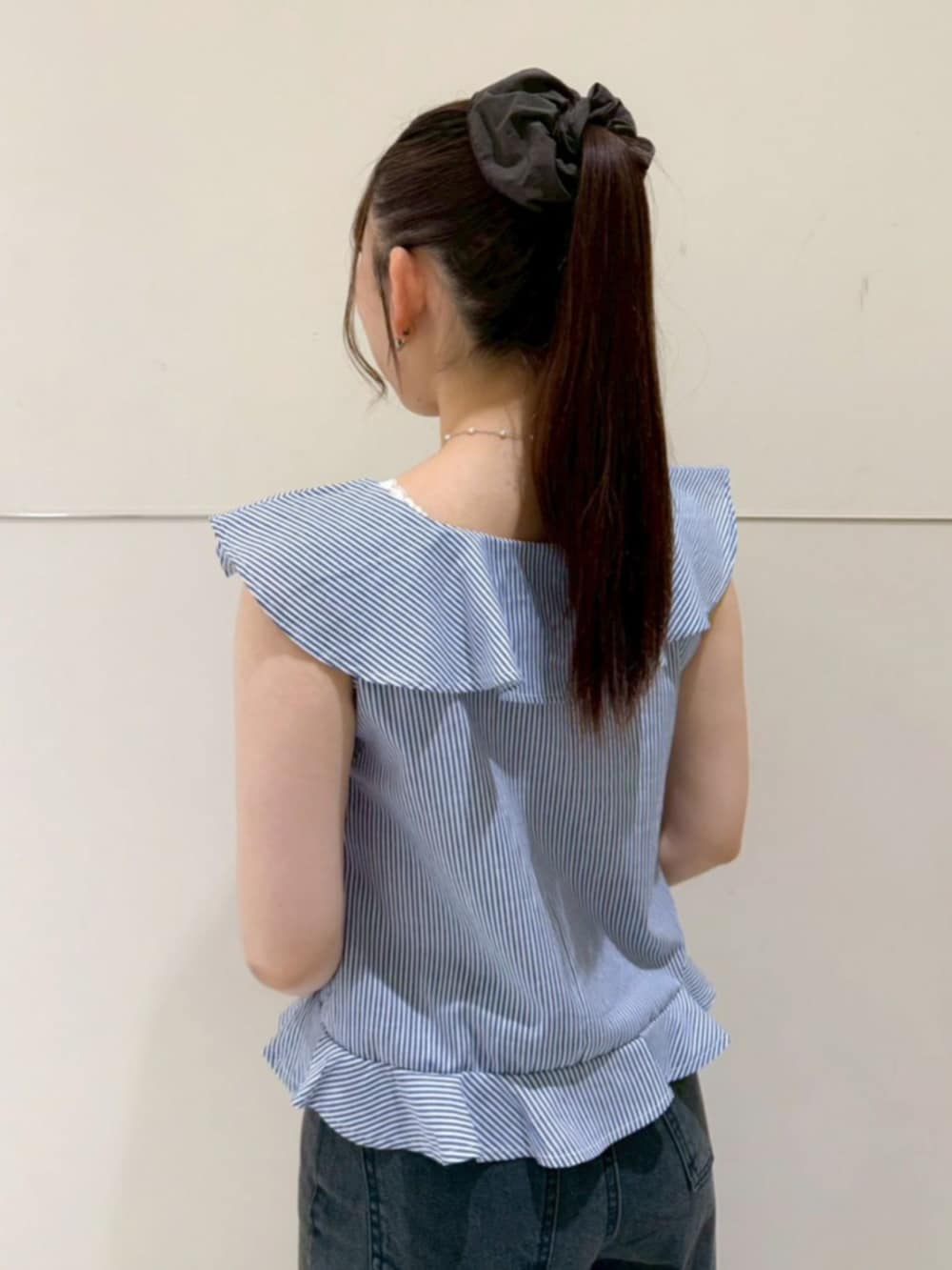 ブラック系のデニムパンツ、ホワイト系のトートバッグ、ブルー系のシャツ/ブラウスを着用したレディースの夏コーディネートの3枚目の写真