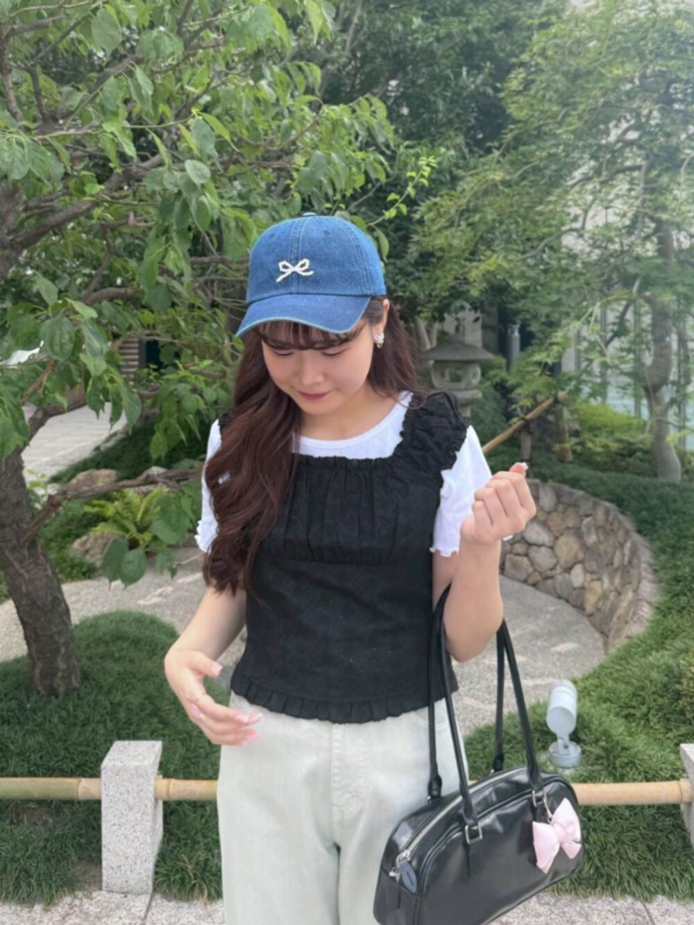 グリーン系のデニムパンツ、ホワイト系のTシャツ/カットソー、ブラック系のシャツ/ブラウスを着用したレディースの夏コーディネートの2枚目の写真