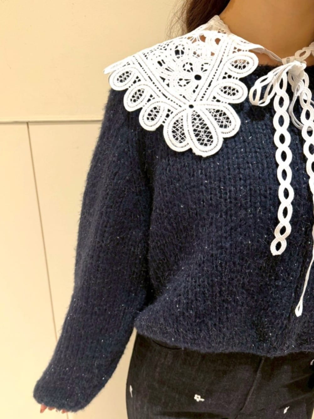 ブラック系のショルダーバッグ、ブルー系のニット/セーター、ブラック系のデニムパンツを着用したレディースの冬コーディネートの3枚目の写真