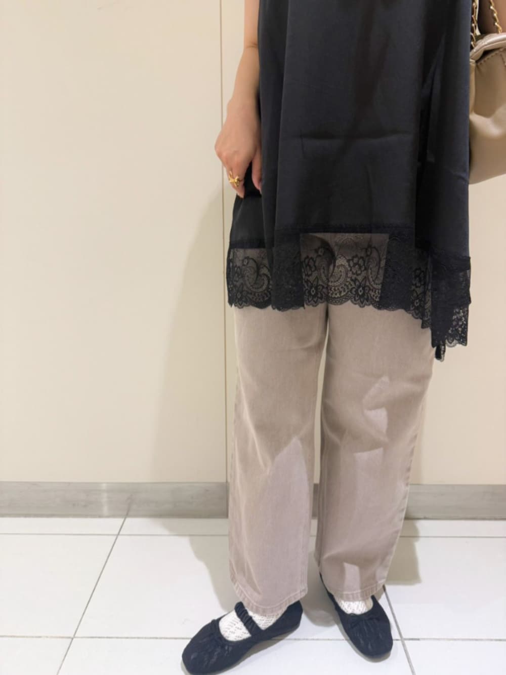 ベージュ系のショルダーバッグ、ホワイト系のTシャツ/カットソー、ブラック系のキャミソールを着用したレディースの夏コーディネートの3枚目の写真