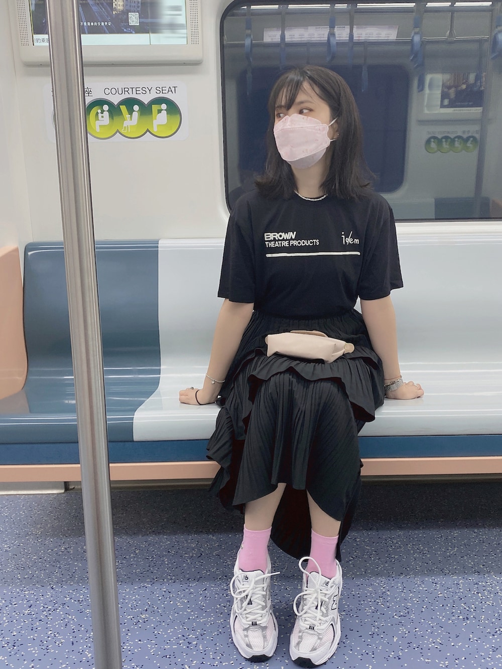 ブラック系のTシャツ/カットソー、ブラック系のスカート、ピンク系のバッグを着用したレディースの夏コーディネートの2枚目の写真