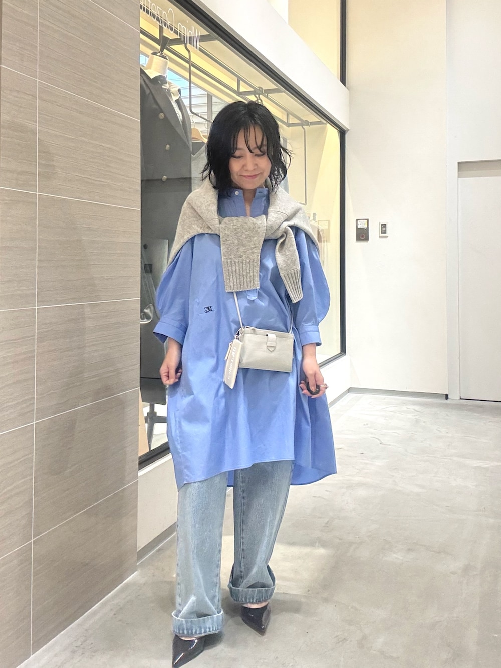 ブルー系のデニムパンツ、ブルー系のシャツ/ブラウス、グレー系のカーディガン/ボレロを着用したレディースの春コーディネートの2枚目の写真