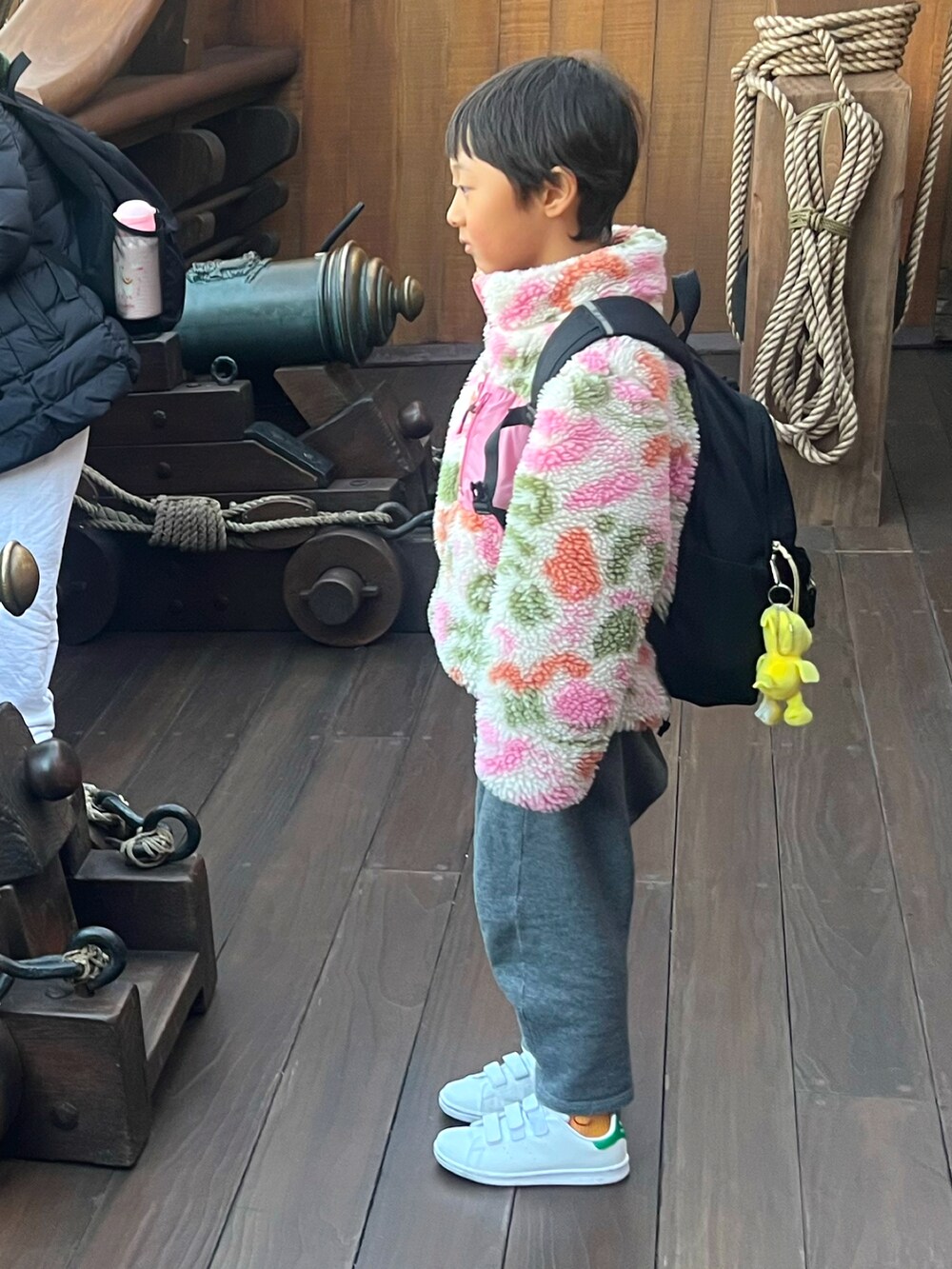 ピンク系のブルゾン、グレー系のスウェットパンツ、ホワイト系のスニーカーを着用したレディースの冬コーディネートの3枚目の写真
