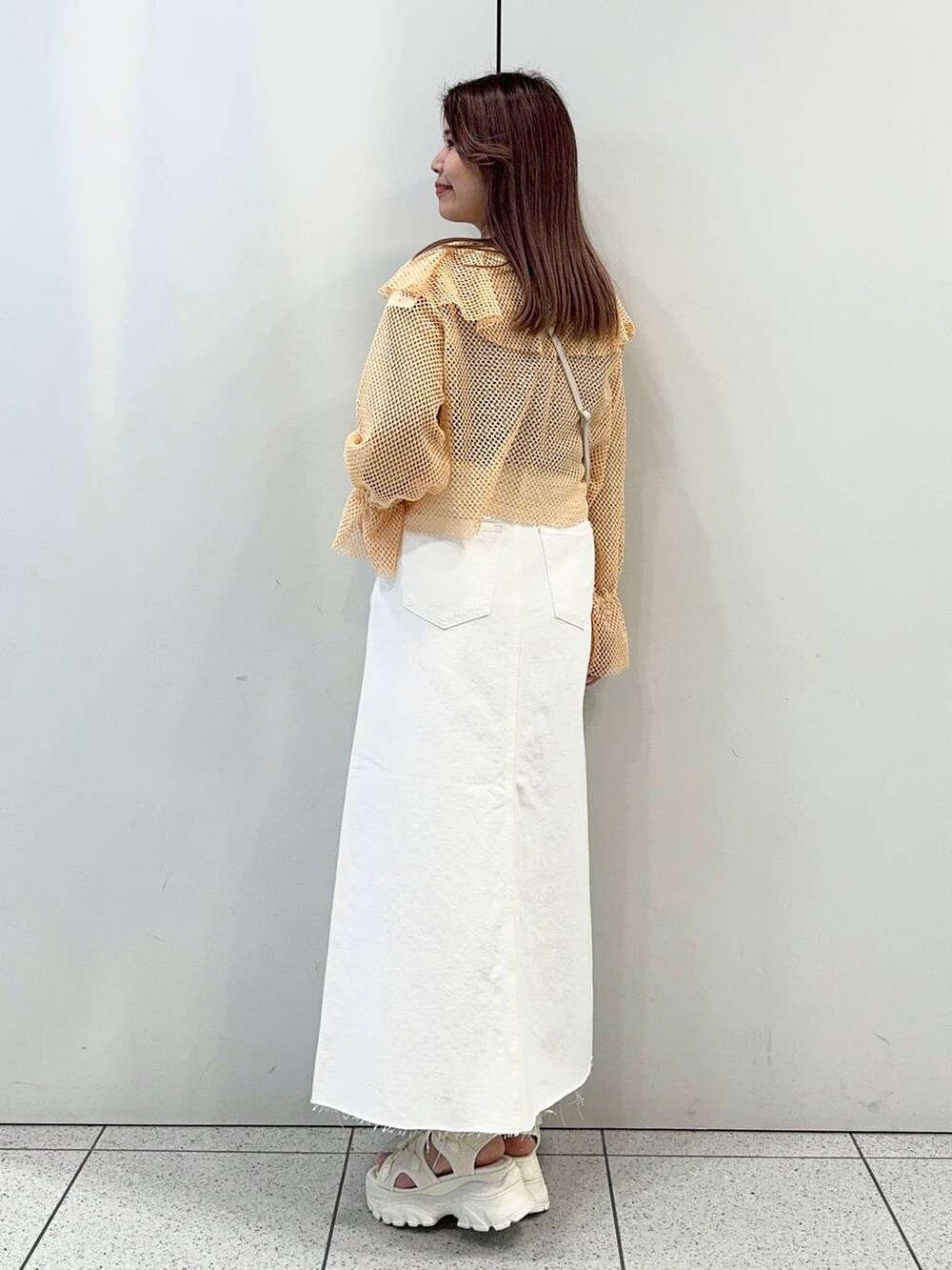 ベージュ系のショルダーバッグ、ホワイト系のサンダル、ブラック系のタンクトップを着用したレディースの春コーディネートの3枚目の写真