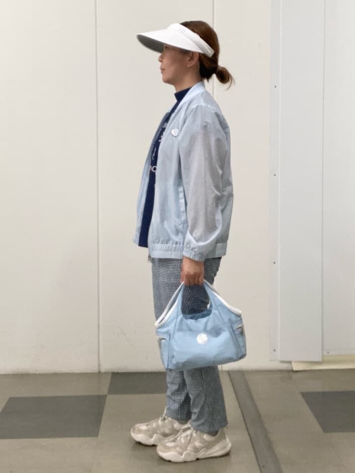 ブルー系のその他パンツ、ブルー系のショルダーバッグ、ホワイト系のサンバイザーを着用したレディースの春コーディネートの2枚目の写真