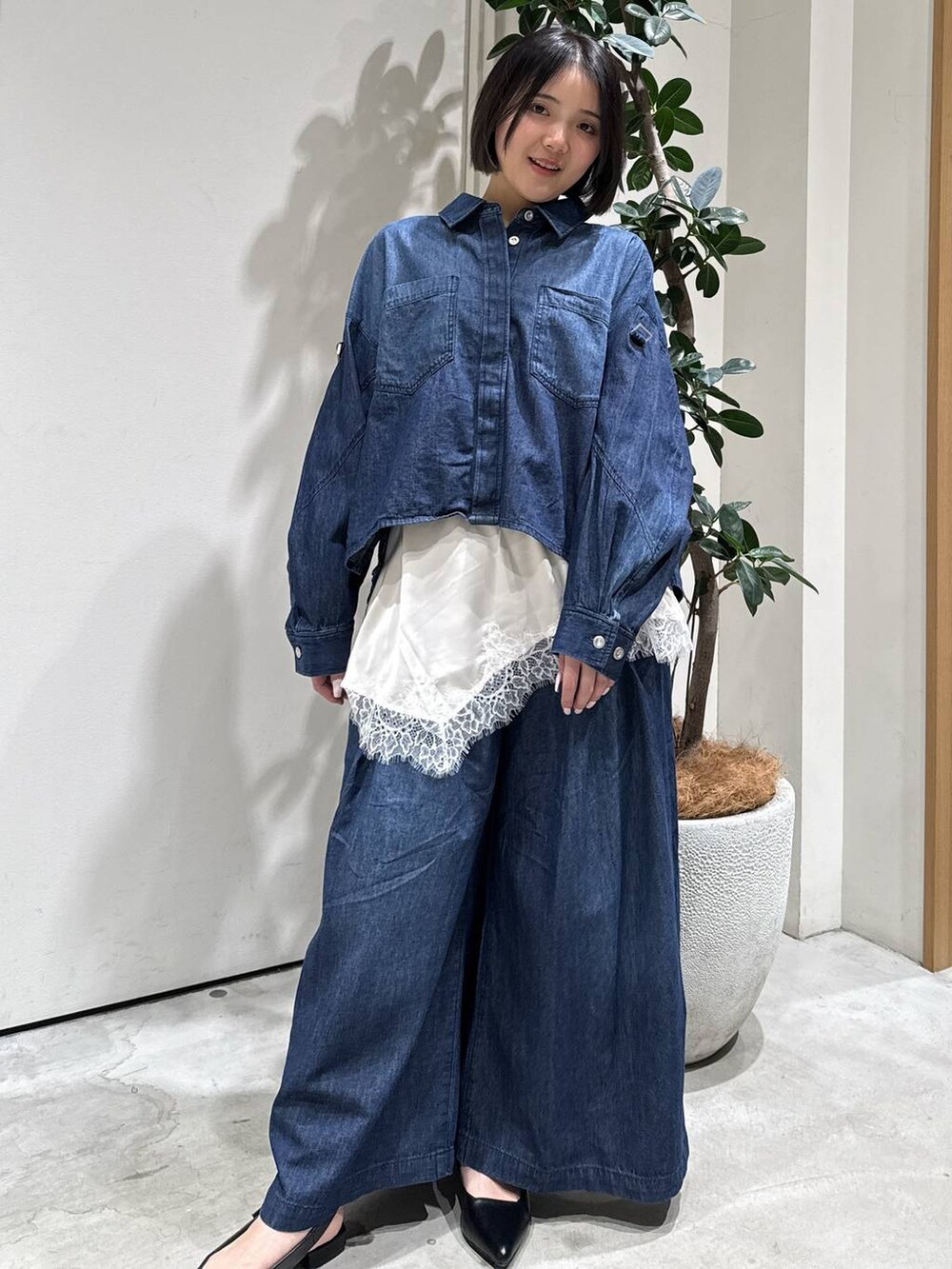 ブラック系のパンプス、ベージュ系のキャミソール、ブルー系のシャツ/ブラウスを着用したレディースの冬コーディネートの2枚目の写真