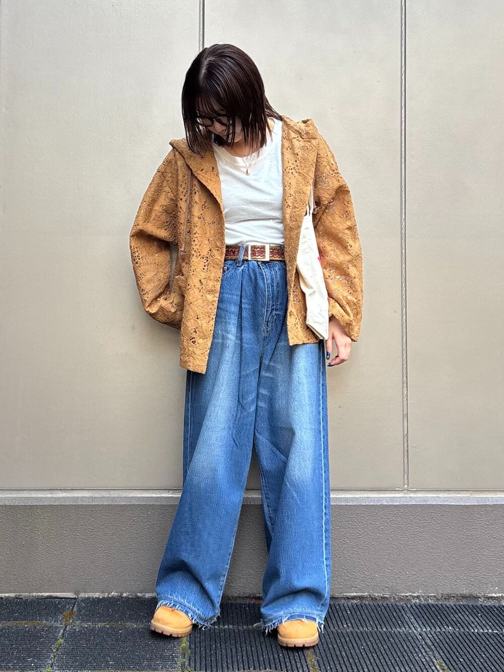 ブルー系のデニムパンツ、イエロー系のシャツ/ブラウス、ホワイト系のTシャツ/カットソーを着用したレディースの春コーディネートの4枚目の写真