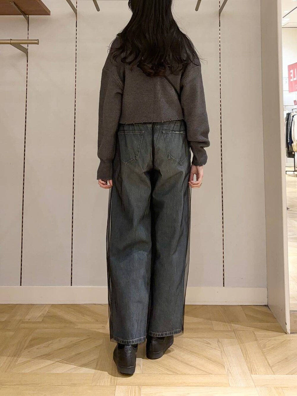 ブラック系のその他パンツ、ブラック系のショルダーバッグ、ブルー系のデニムパンツを着用したレディースの冬コーディネートの3枚目の写真