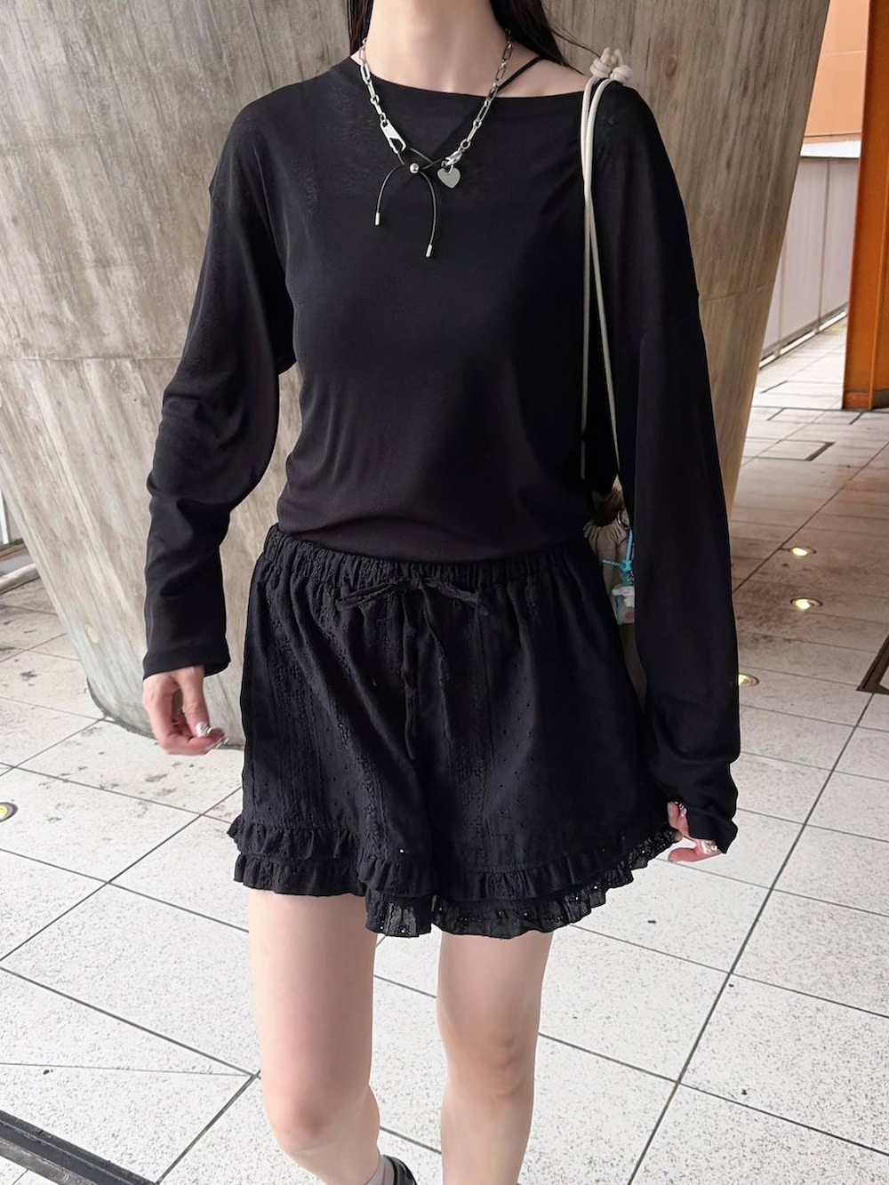 ホワイト系のショルダーバッグ、ブラック系のTシャツ/カットソーを着用したレディースの秋コーディネートの3枚目の写真
