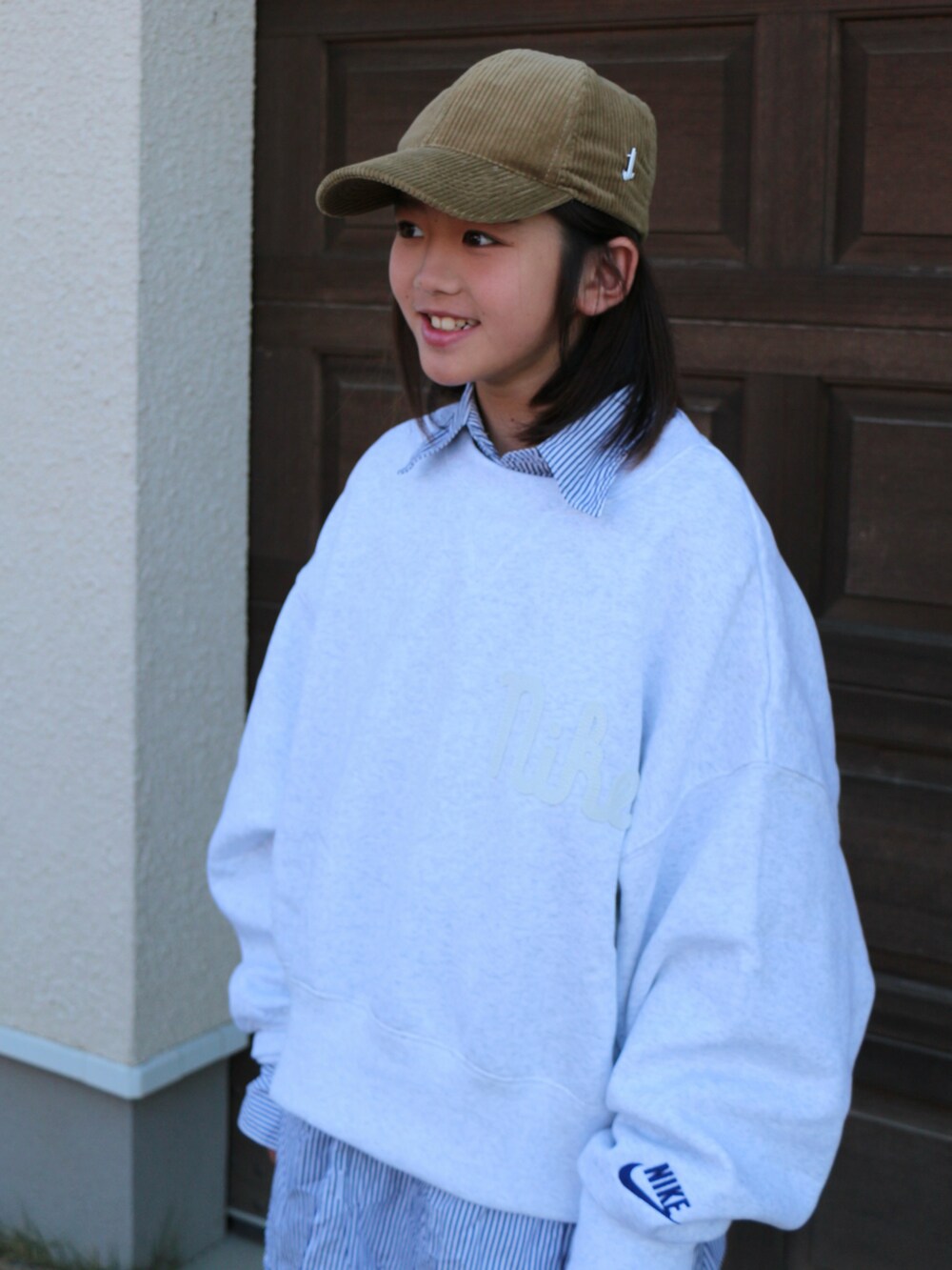 ホワイト系のスウェット、グレー系のパンツ、ベージュ系のスニーカーを着用したキッズの秋コーディネートの3枚目の写真