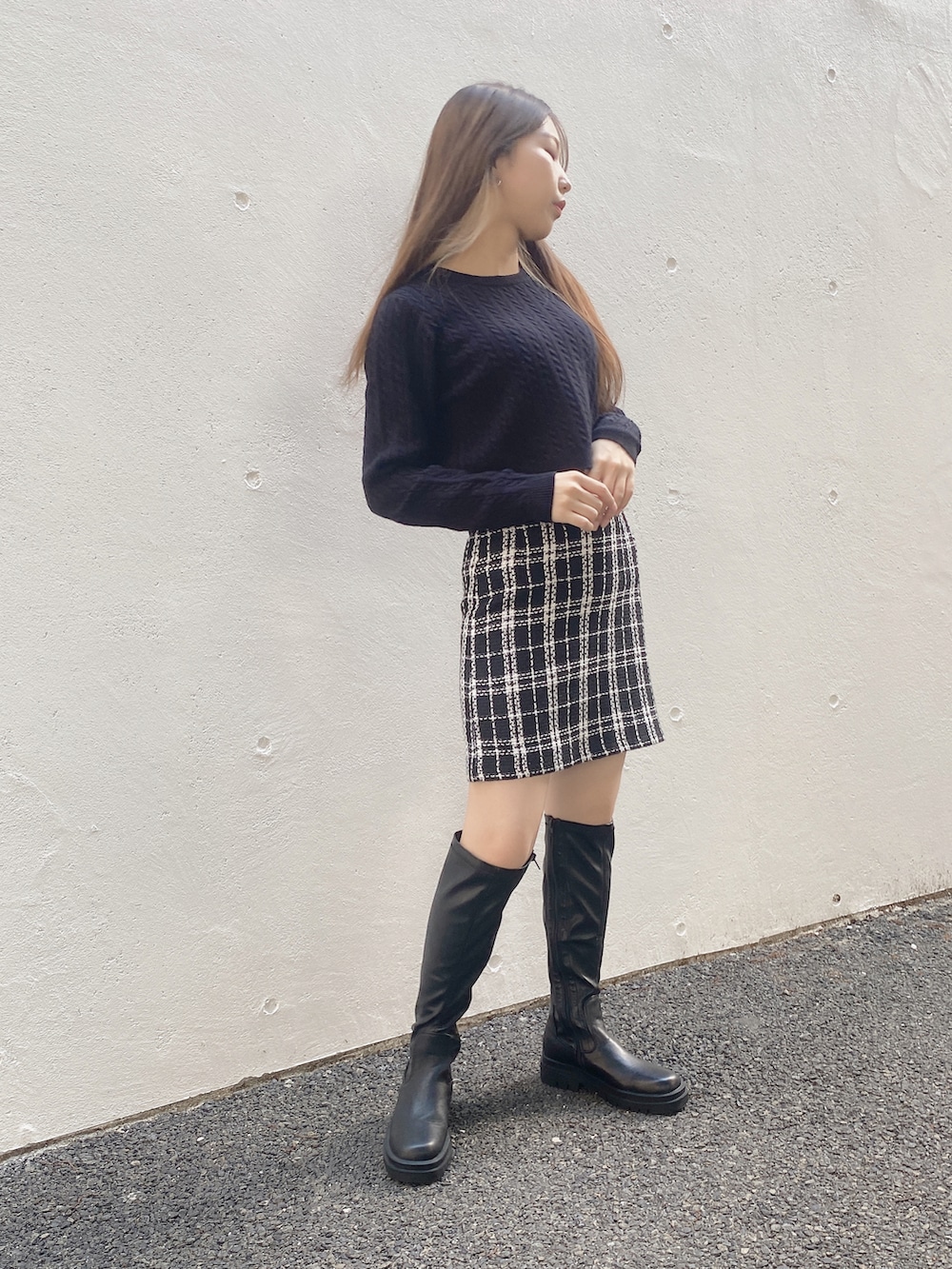 ブラック系のニット/セーター、ブラック系のスカートを着用したレディースの秋コーディネートの3枚目の写真
