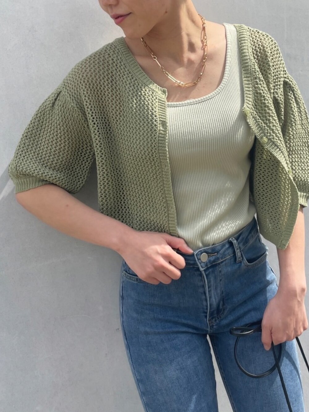 ブルー系のデニムパンツ、グリーン系のキャミソール、グリーン系のカーディガン/ボレロを着用したレディースの夏コーディネートの2枚目の写真