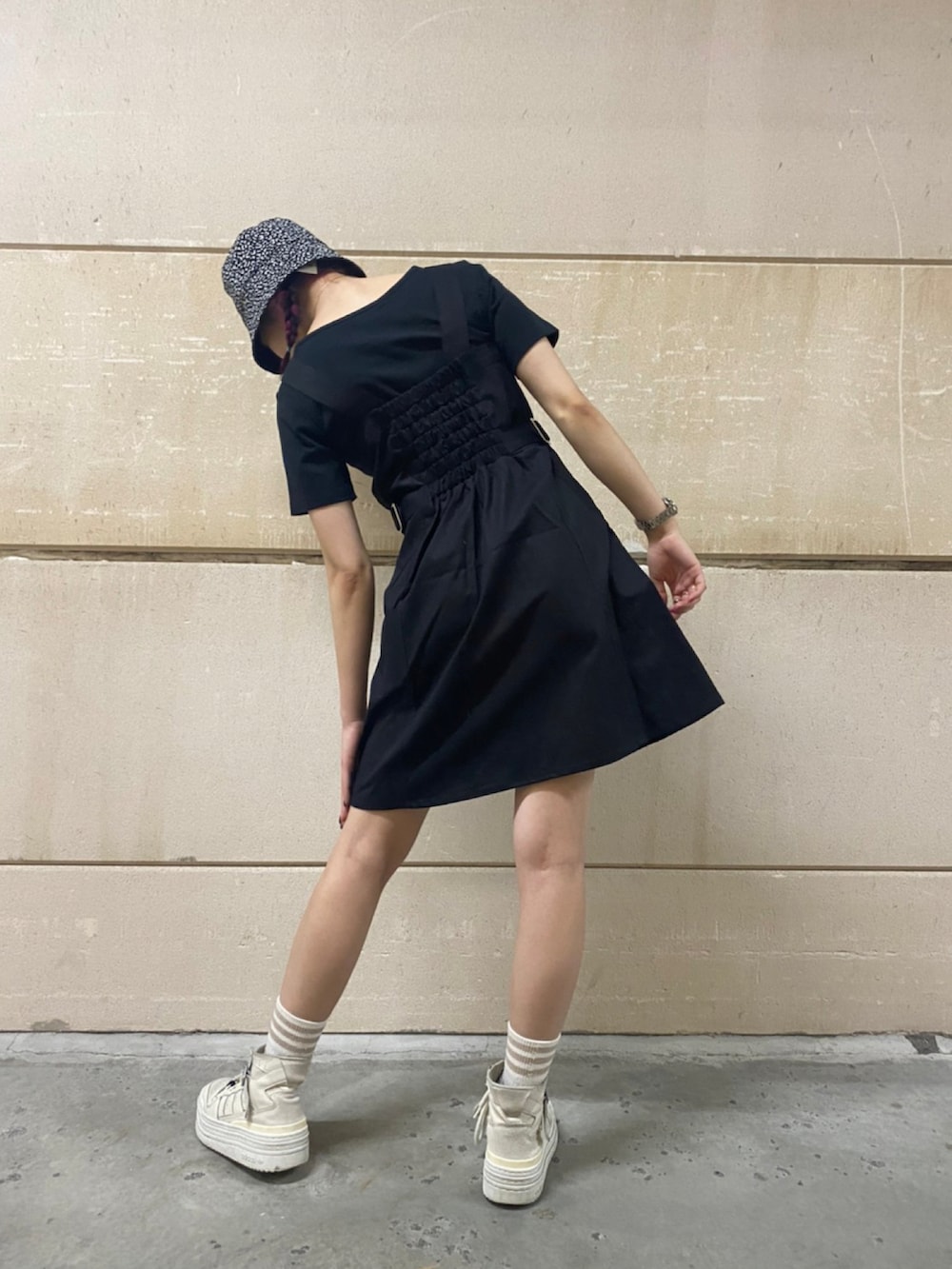 ブラック系のジャンパースカート、ブラック系のTシャツ/カットソーを着用したレディースの夏コーディネートの4枚目の写真